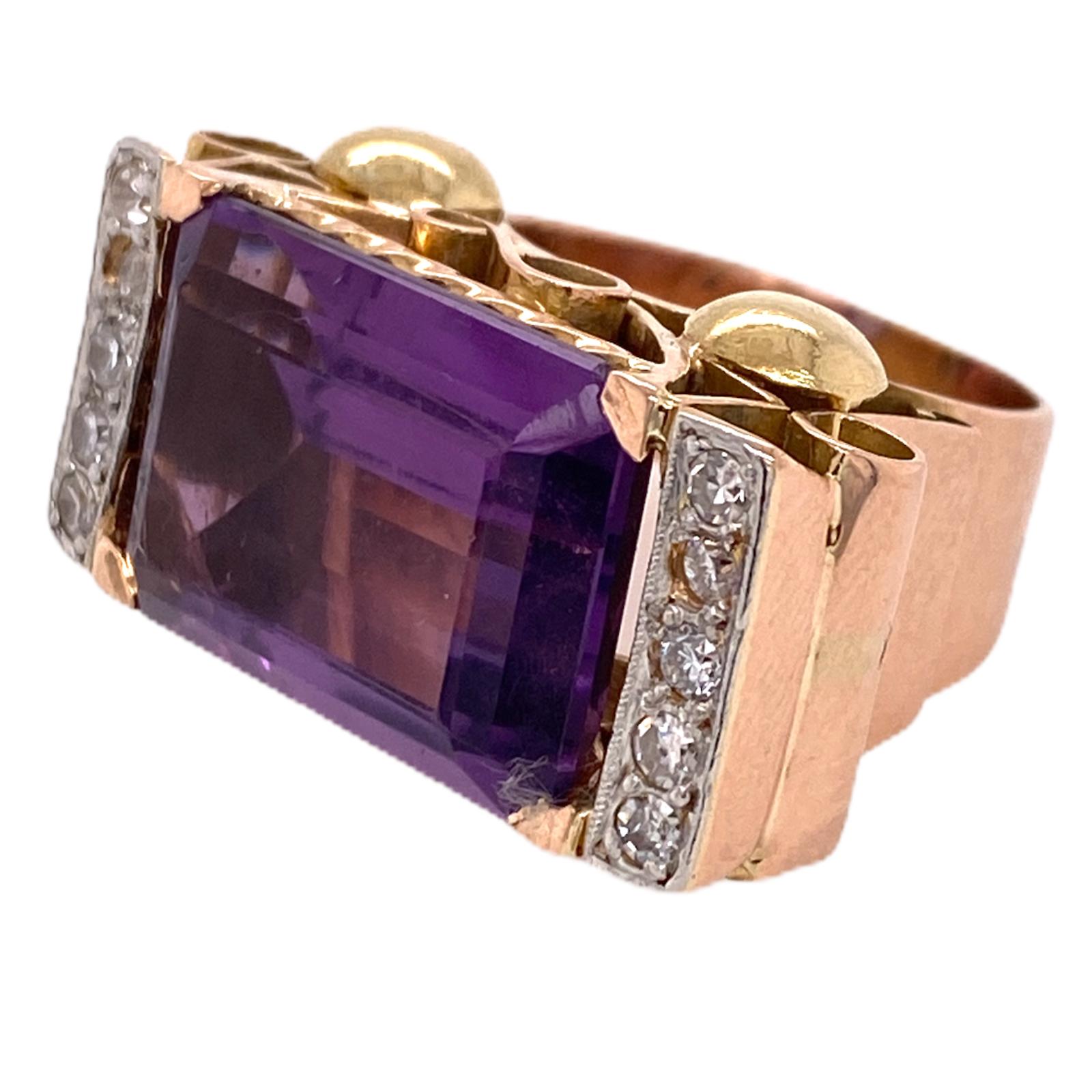 Fabulous Retro amethyst and diamond ring fashioned in 18 karat rose and yellow gold.  The emerald cut amethyst weighs approximately 14 carats and measures 13 x 19.5 mm. The amethyst is flanked by 10 single cut diamonds weighing .50 carat total