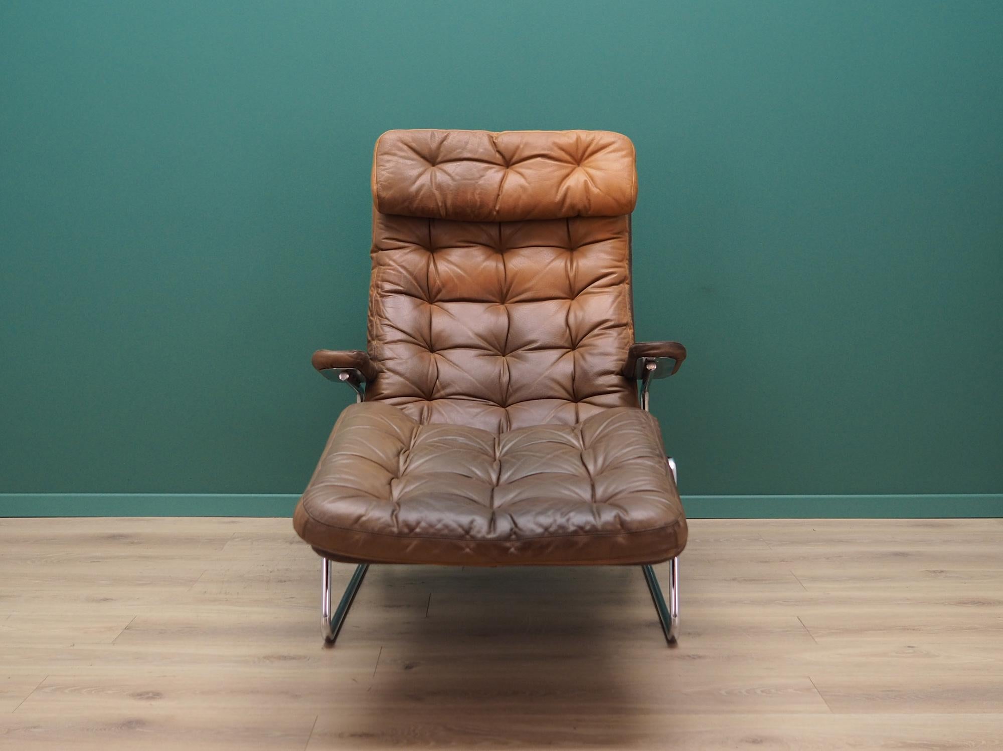 Fantastic armchair from the 1960s-1970s. Scandinavian design, Minimalist form. Original upholstery made of brown leather, construction made of chromium plated metal. Armchair has adjustable back and seat tilt account. Preserved in good condition