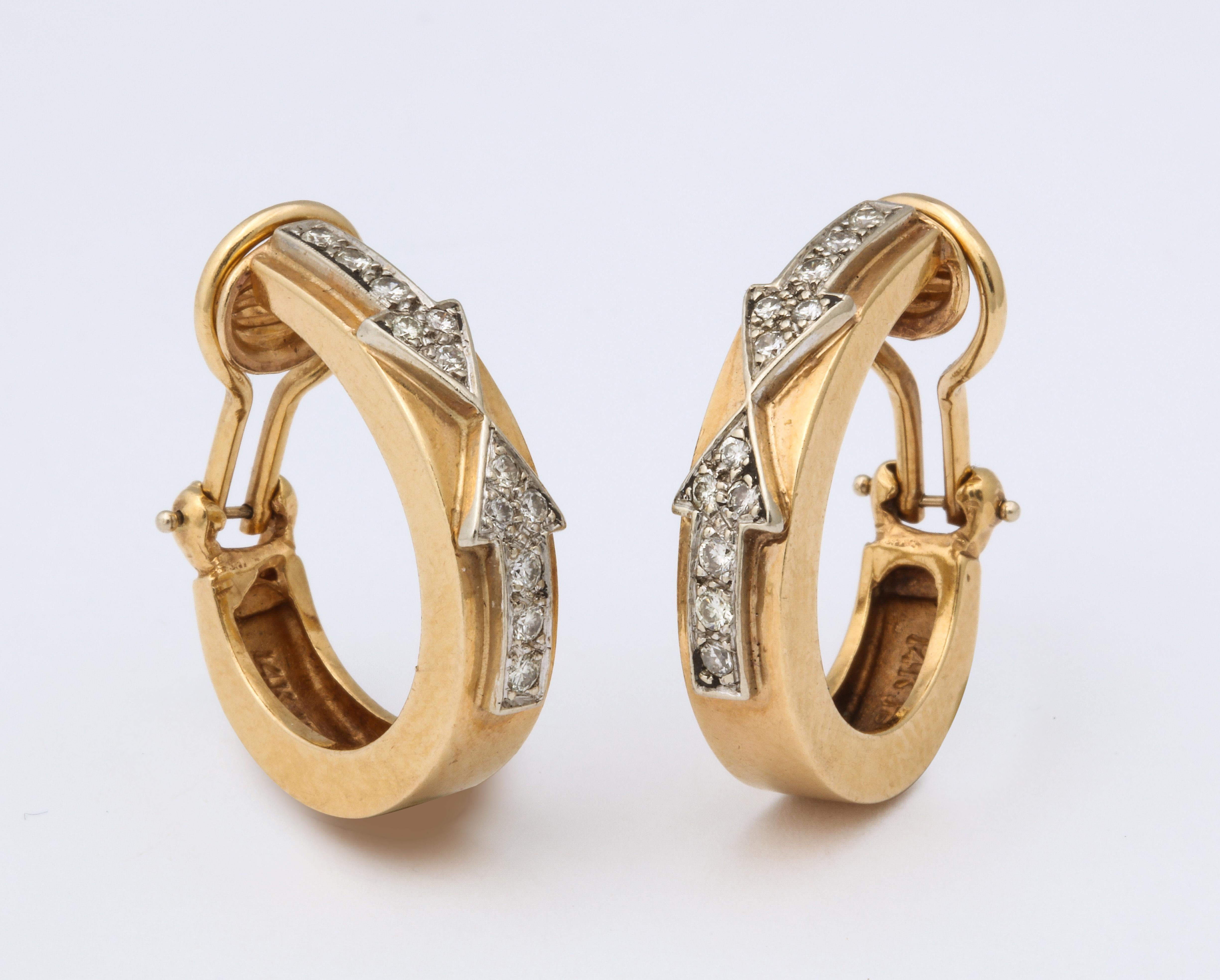 A classic pair of Retro Arrow Design Diamond and Gold Hoop Earrings. Diamond encrusted arrows point toward each other on 14k gold clip hoop body.