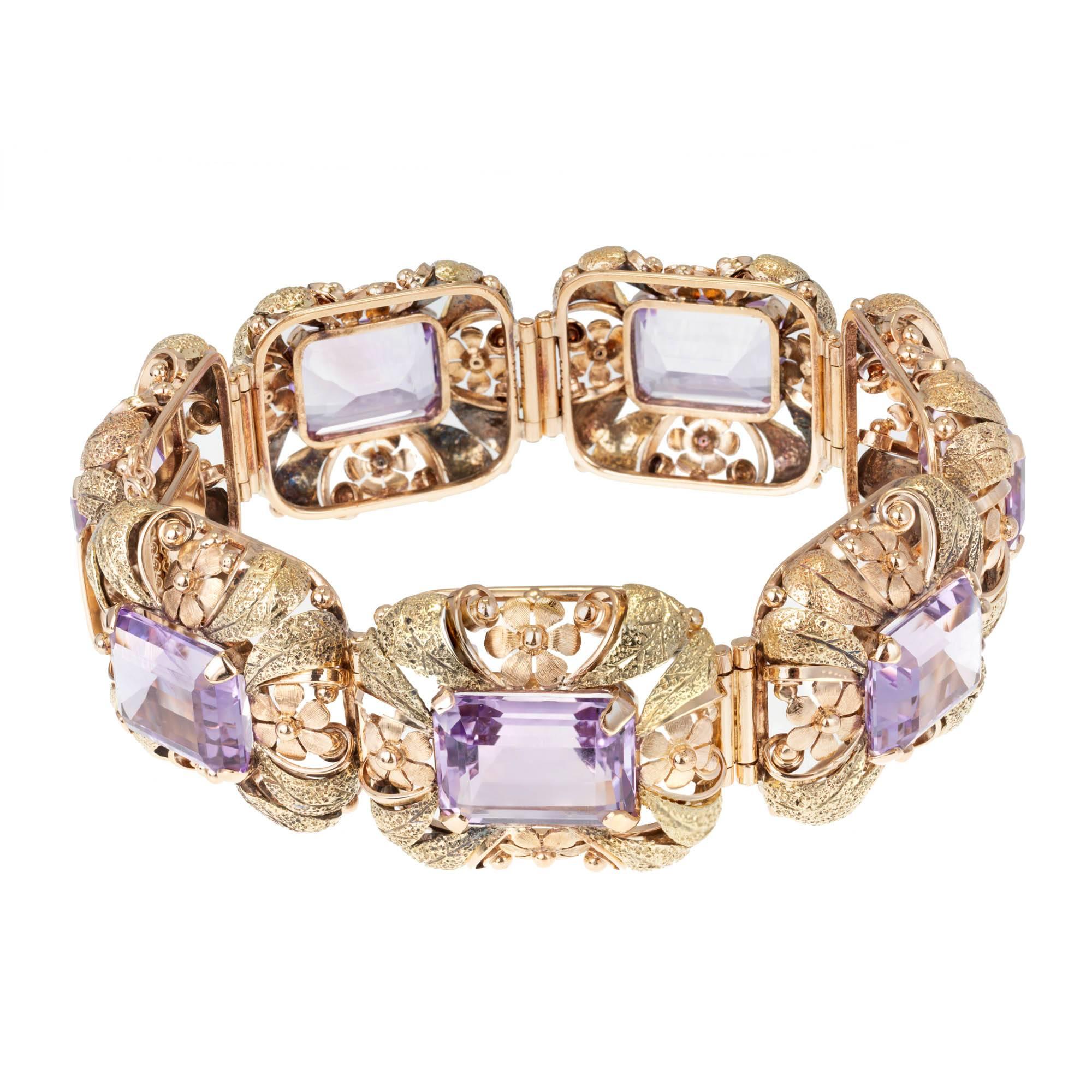 Handmade pink and green gold 7 section amethyst hinged bracelet. Hand formed flower motif 3-D Sections hinged sections. Set with 7 genuine Emerald cut Amethyst GIA certified as natural. Well matched soft purple. Circa 1930.
Please see our matching