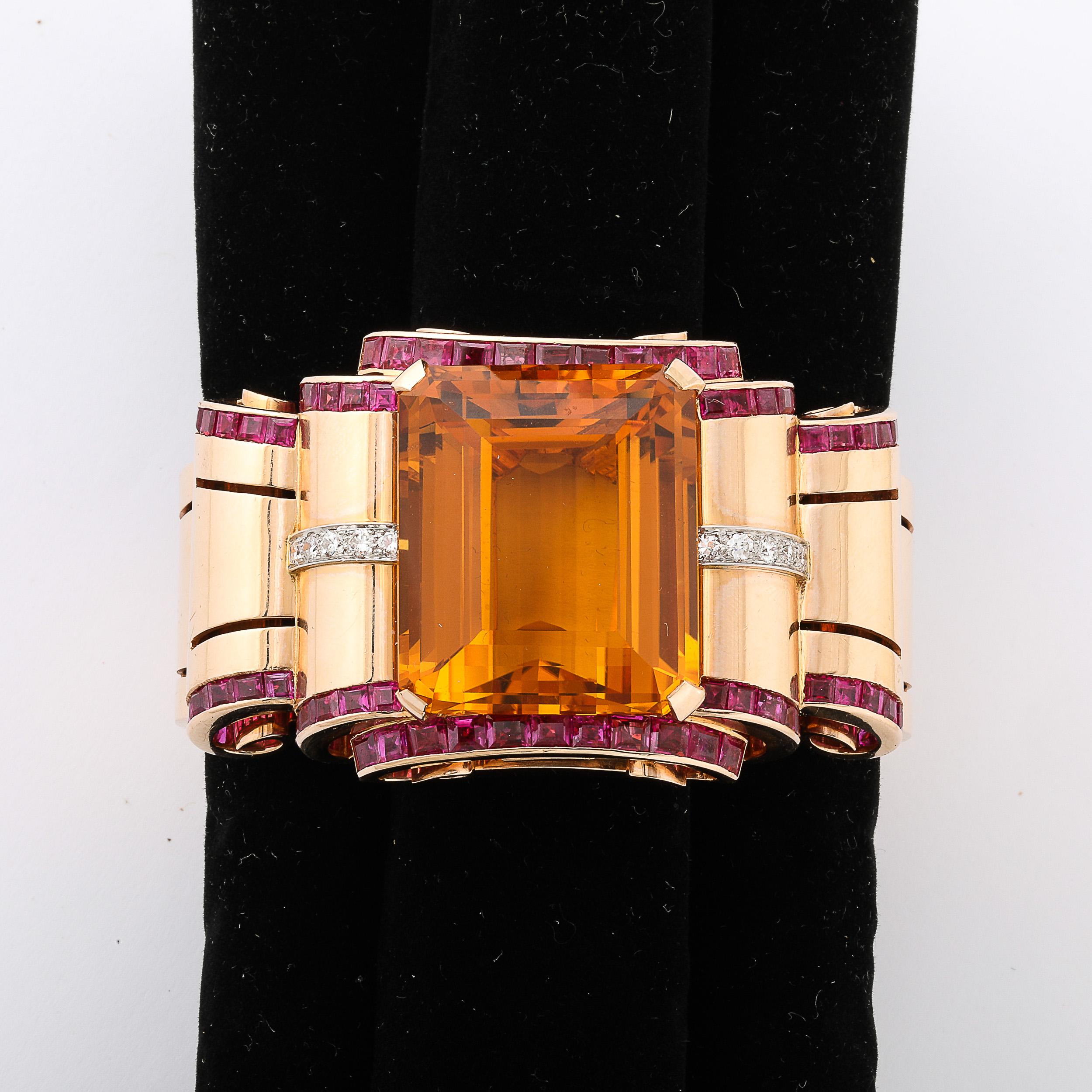 This striking an exquisitely made Retro Art Deco Cuff Bracelet in 14 Karat Gold W/ Citrine, Rubies, and Diamonds is designed and crafted in the United States during the Retro Art Deco Era of the 1940s. This elegant cuff bracelet features a