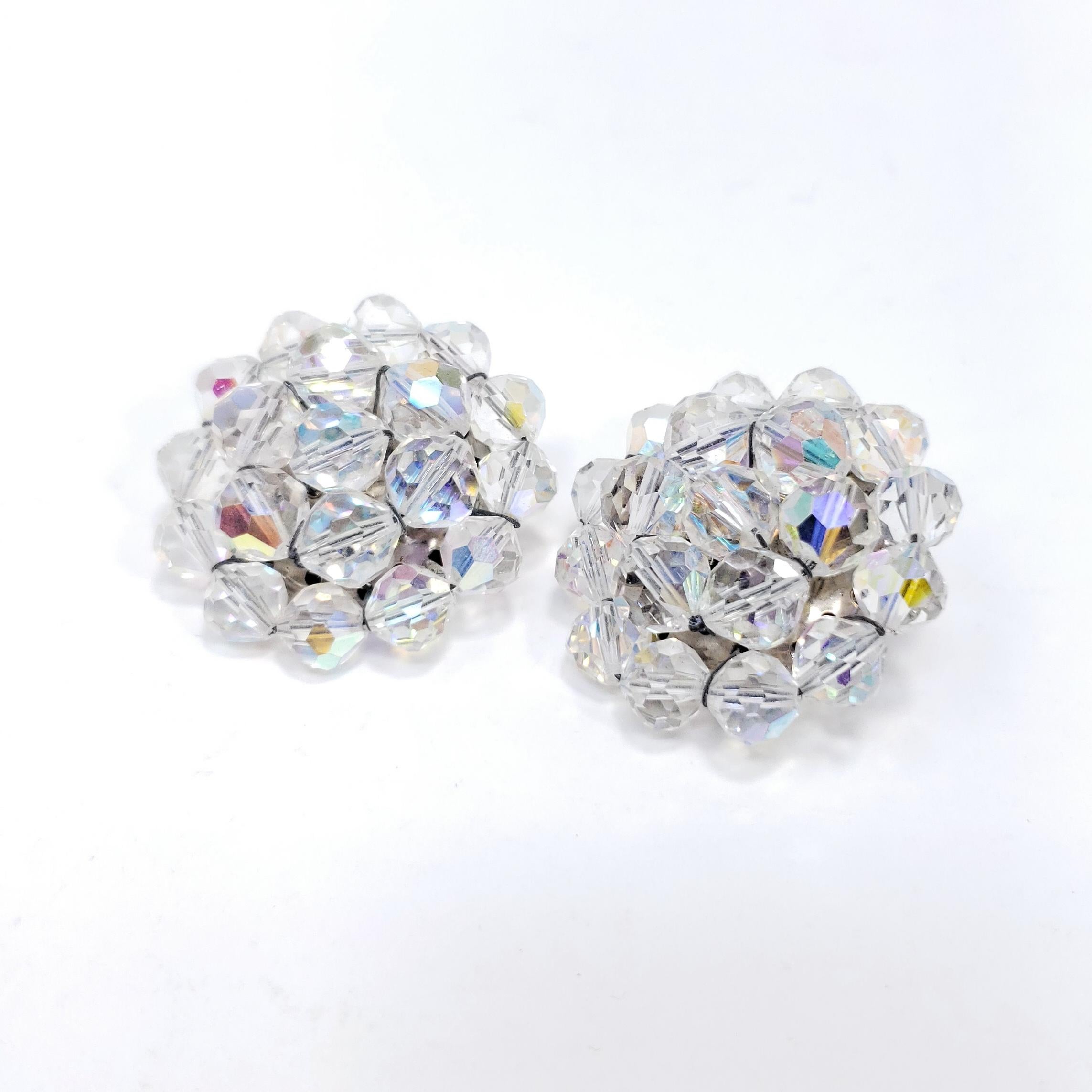 Retro chic! These vintage clip on earrings feature a cluster of clear aurora borealis crystals set on a silver-tone clip.

Circa late 1900s.