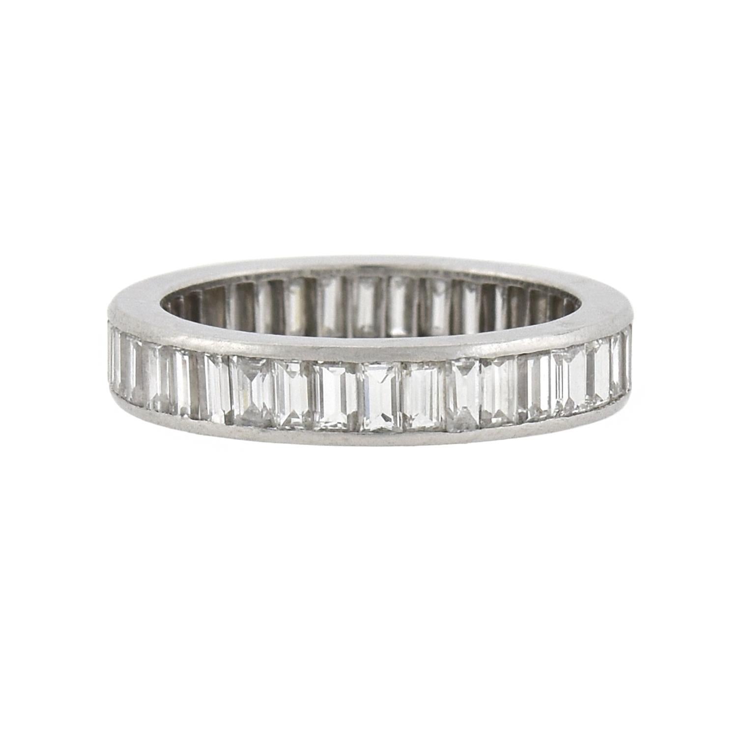 A stunning diamond eternity band from the Retro (ca1940) era! This gorgeous piece is crafted in platinum and features of a single row of Baguette Cut diamonds, all held within a smooth channel setting. Collectively, the diamonds weigh approximately
