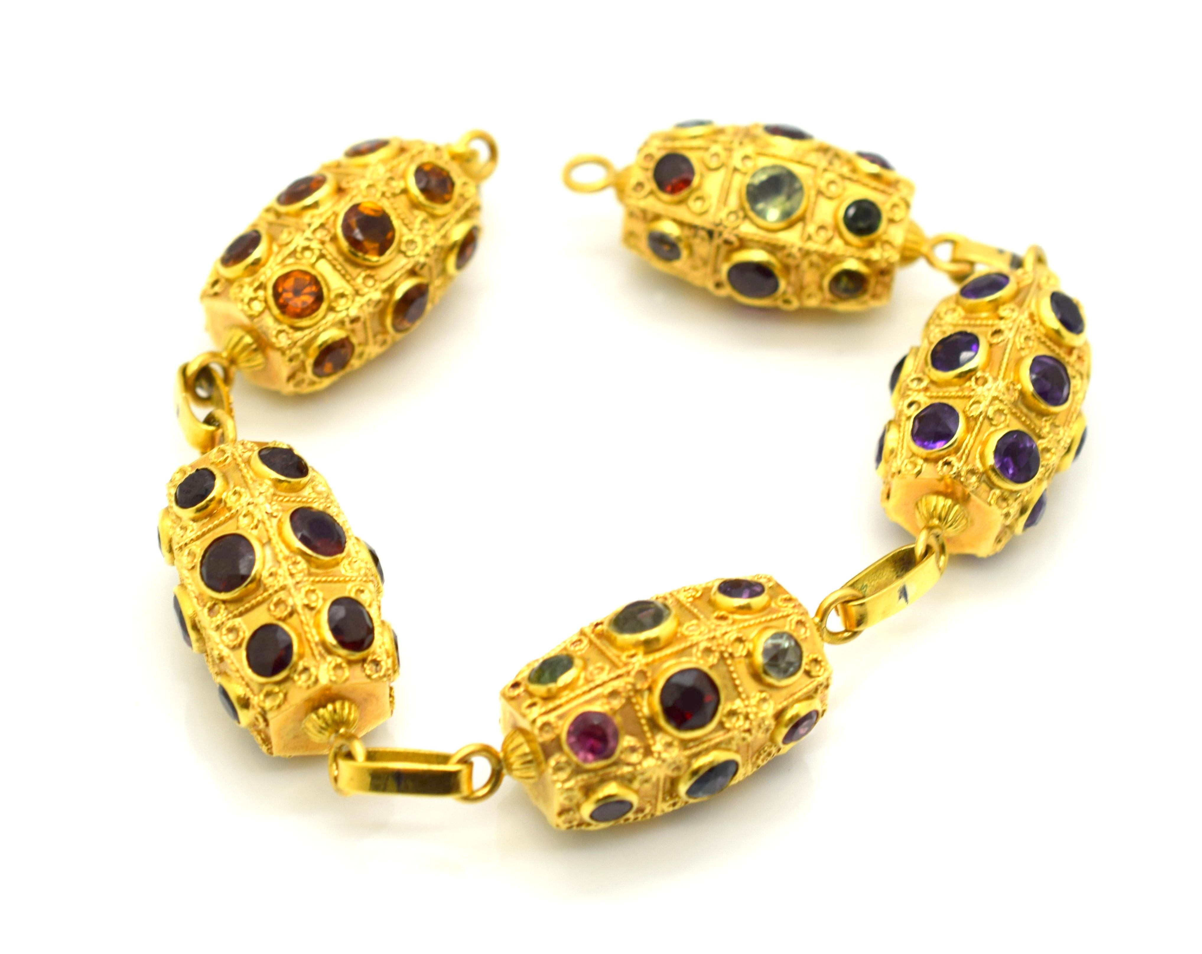 Amazing detail on this Retro Bracelet.  Bracelet is crafted out of 18k yellow gold and made in Italy. Exquisite design is seen on this barrel link bracelet as details are seen across the entire piece. Semi Precious gemstones are bezel set throughout