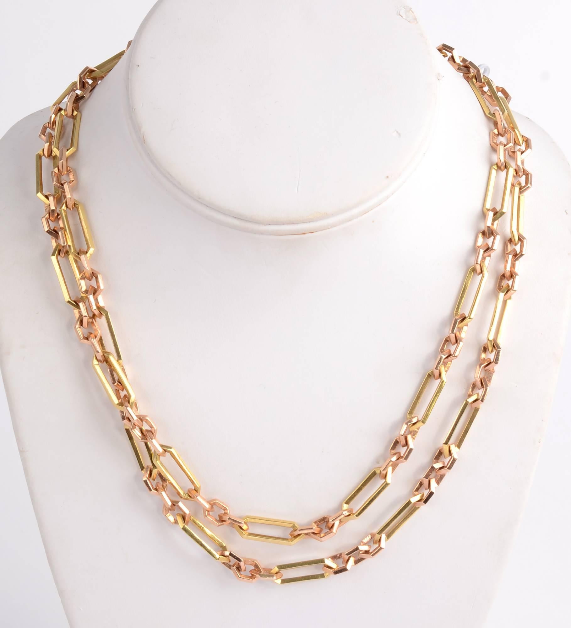 Retro endless chain necklace of pink and yellow gold.  Groups of three small links of pink gold alternate with longer yellow ones of 18 karat. The edges of the links are flat making for many planes and creating a nice reflective quality. The
