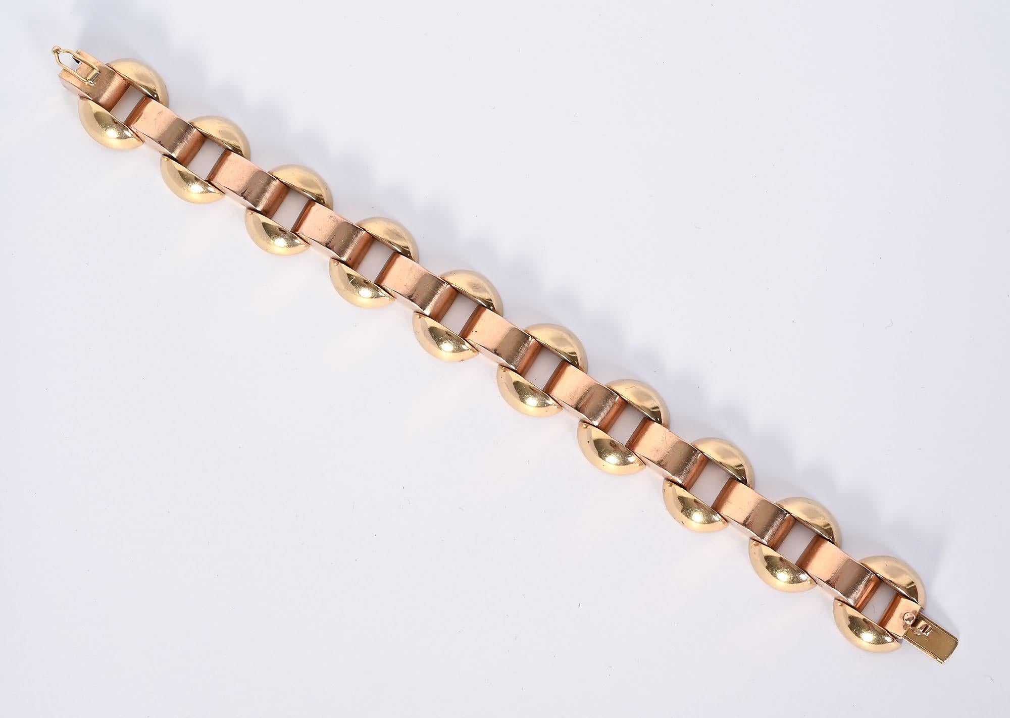 Classic Retro bracelet with both yellow and rose gold. Oval links of yellow gold are surmounted by pink gold arched links. The bracelet is 7 1/4 inches in wearable length. It is 11/16 inch in width. The bracelet stands well on its own or can be