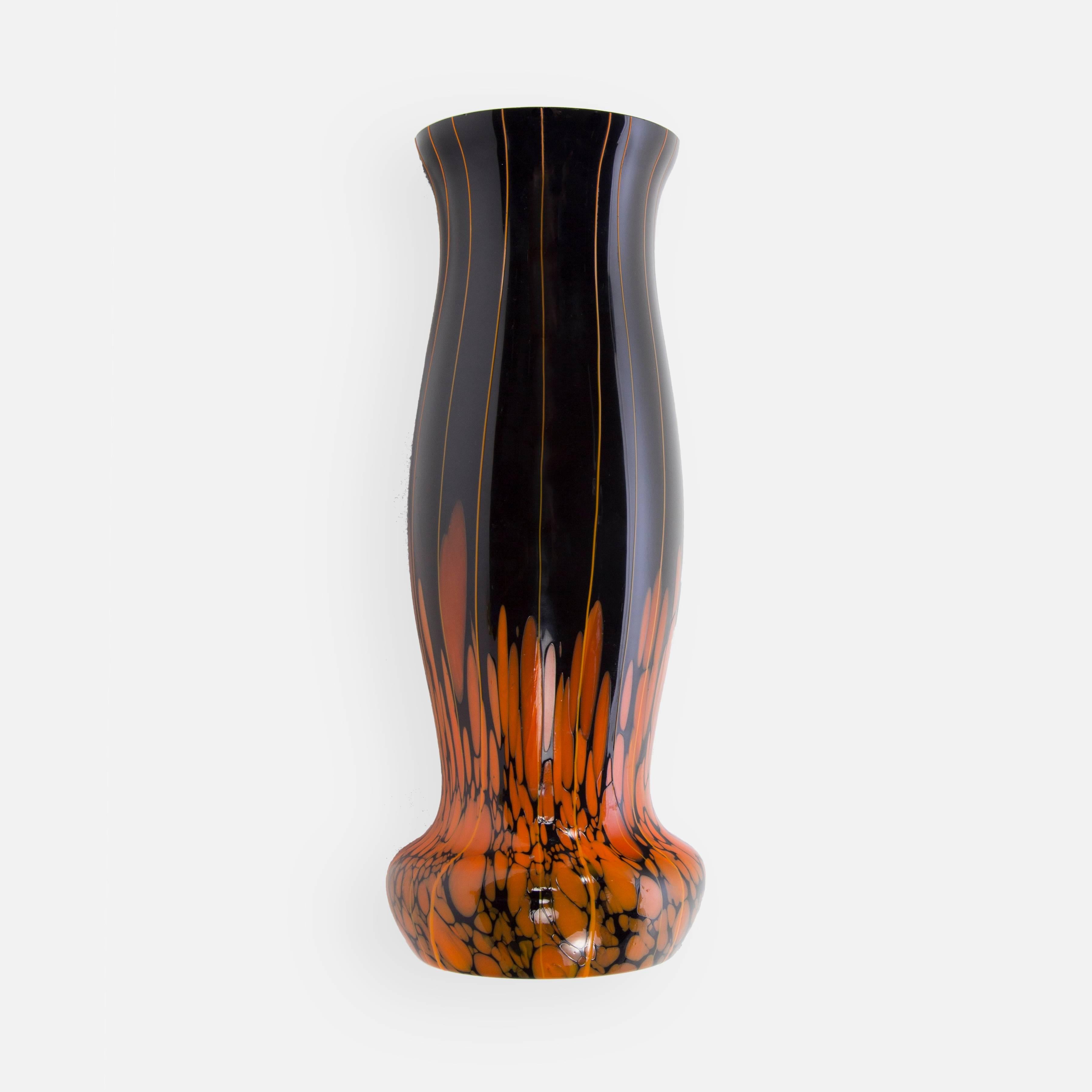 Striking and beautifully handcrafted large retro art glass vase, black and orange heavy glass tapered shape with gorgeous and rare orange swirl designs; midcentury art studio; approximately 12 inches high, circa 1940s era.

 