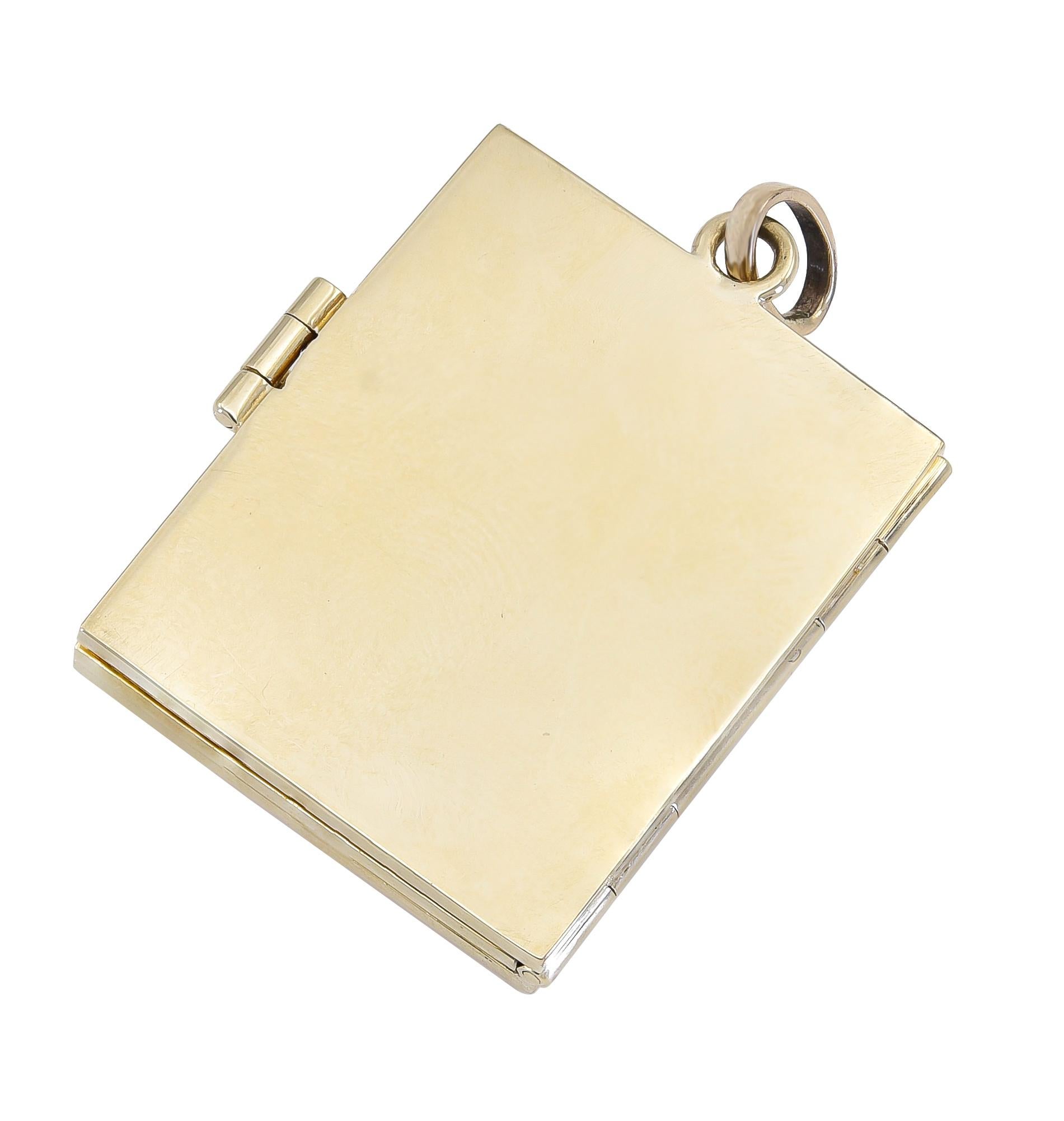 Rectangular book-shape locket. Textured gold center, with shiny gold step-cut border. Figural 