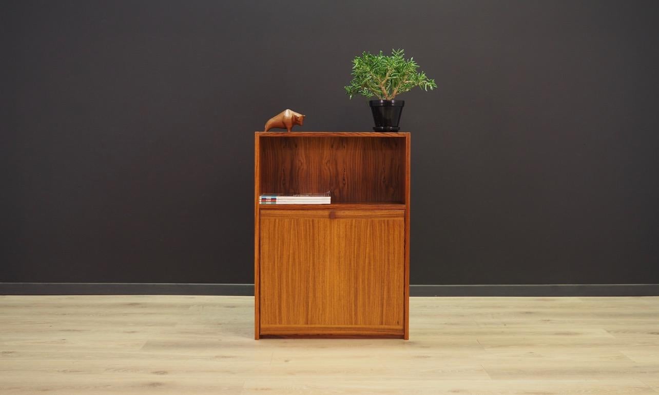 Minimalistic bookcase from the 1960s-1970s, Scandinavian design. The whole veneered with rosewood. The furniture is for hanging, also as advantage it has lighting. Inside the bar there is a glass shelve. Preserved in good condition (minor