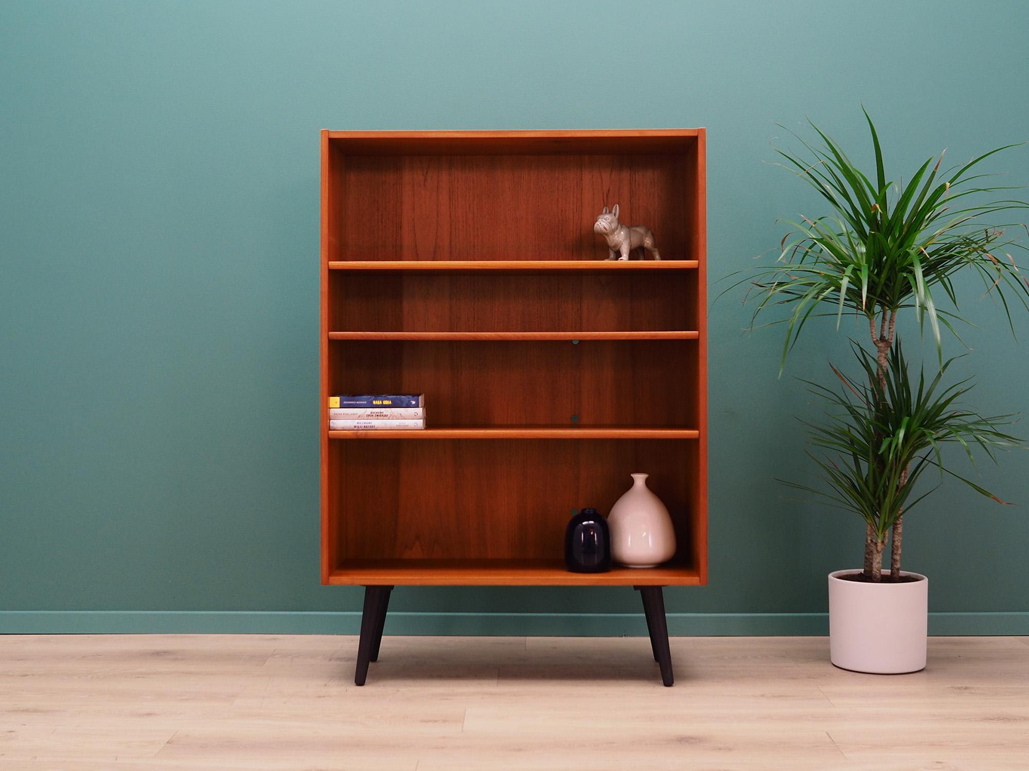 Classic bookcase, library from the 1960s-1970s. Scandinavian design, Minimalist form. The surface of the furniture finished with teak veneer. Shelves with height adjustment. Preserved in good condition (small bruises and scratches, filled veneer