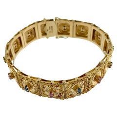 Bracelet rétro Brevetto en or jaune, rubis et saphirs