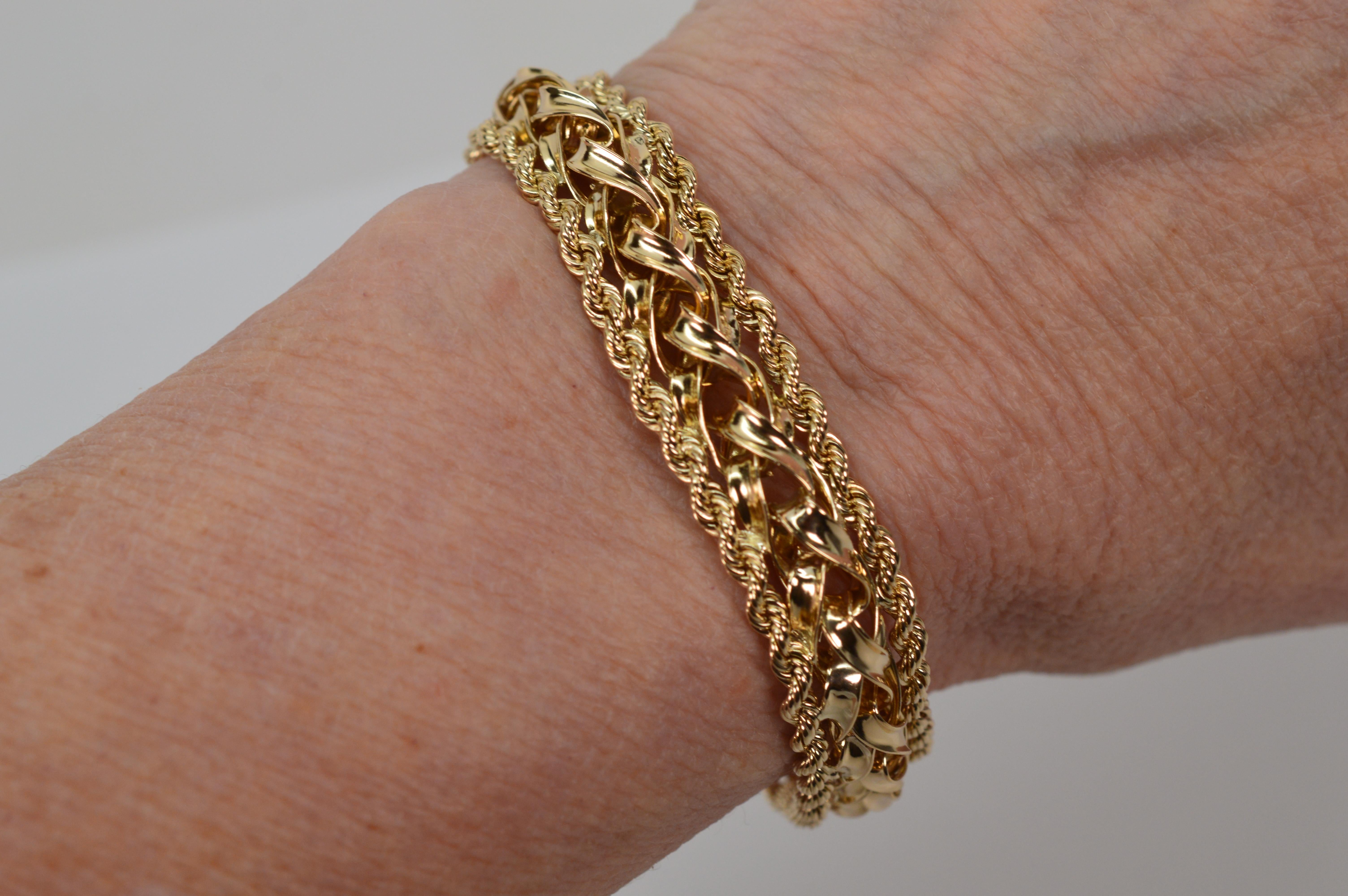 A perfect choice when looking for the bold look of gold but in a modest width. Multi-dimensional, with an interesting braided design, the highly polished 14 karat yellow gold is trimmed with accenting 14 karat yellow gold roping to create this
