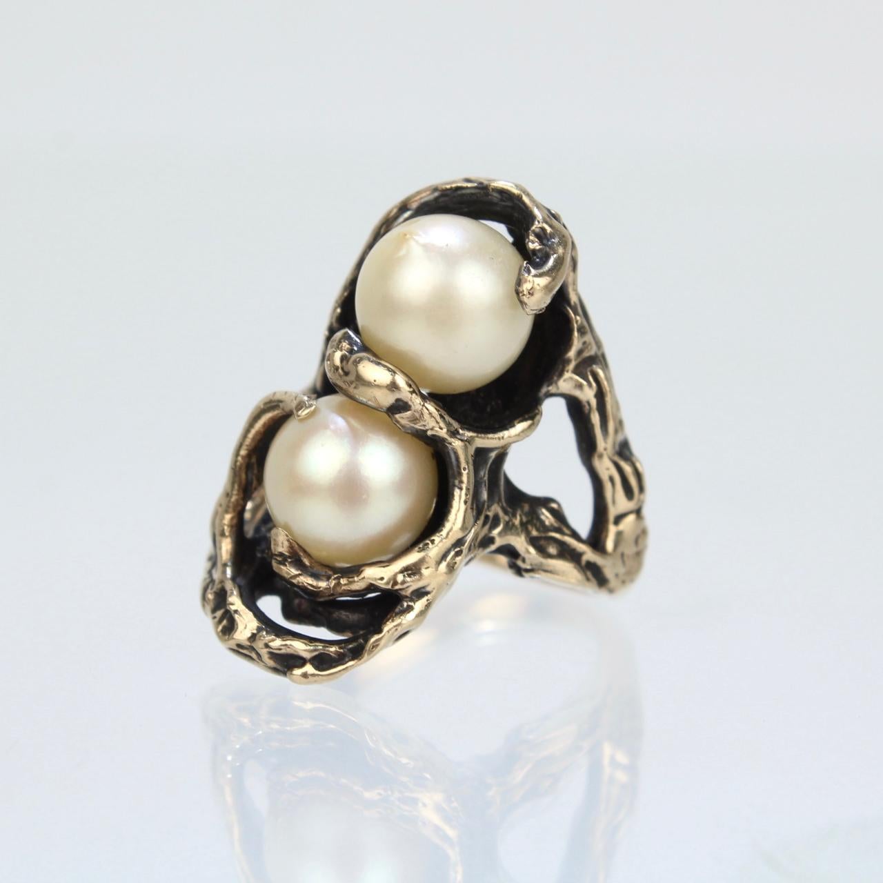 A very fine Brutalist double pearl ring.

Cast In 14k gold and set with 2 round white cultured pearls. 

A cool, organic, modernist twist on the classic moi et toi ring!

Date:
20th Century

Marked:
14k for gold fineness

Measurements: 
Width: ca.