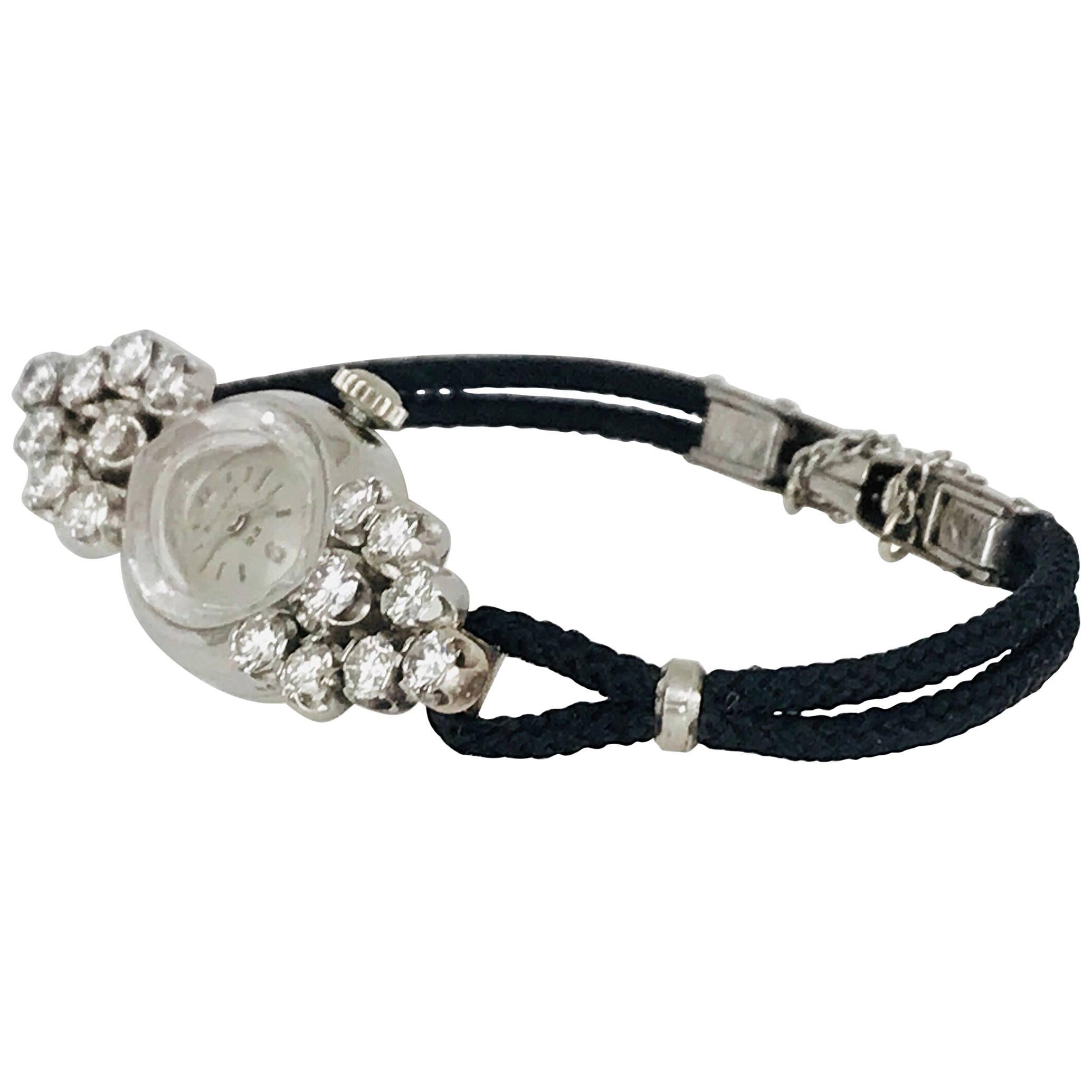 Circa 1960, Retro Bulova 1.75 Carets Diamond & 14 Karat White Gold Cocktail Wrist Watch features a marquis shaped, silver-tone face with with a patterned crystal bezel effect, 14 karat white gold case and stem, and is accented by (16) sparkling