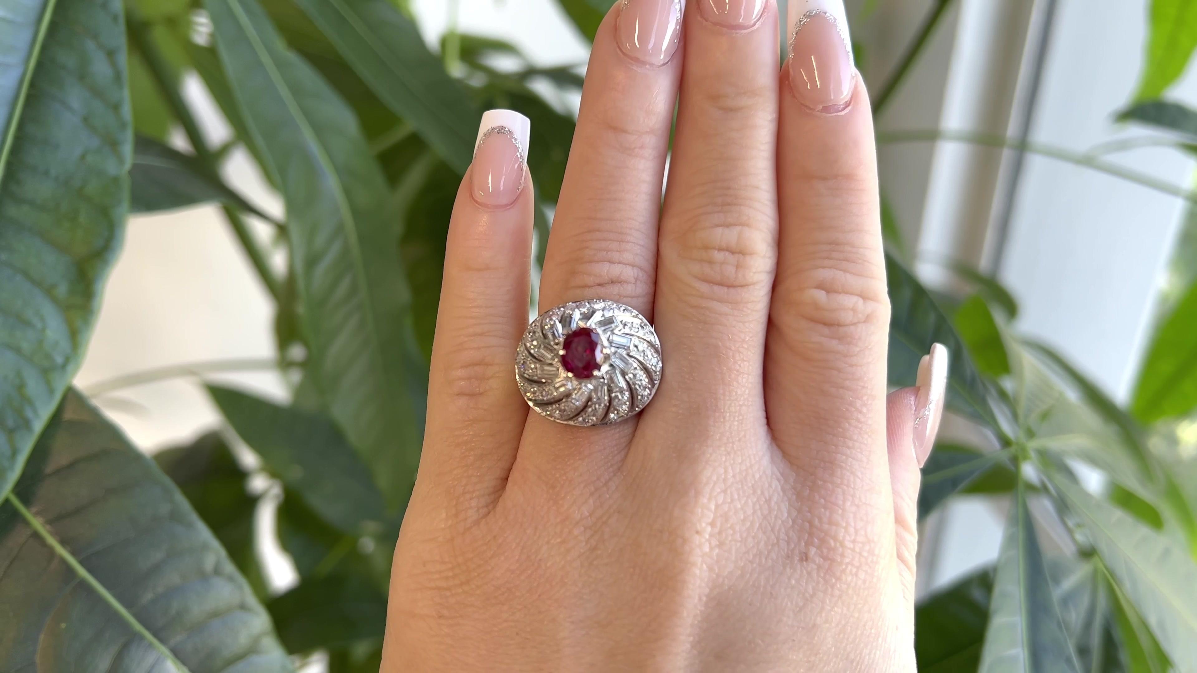 One Retro Ruby Diamond Platinum Dome Ring. Featuring one GRS certified 2.10 carat oval shaped ruby accompanied with certificate #2021-107052. Accented by 12 baguette cut diamonds with a total weight of approximately 1.35 carats, graded F color, VS