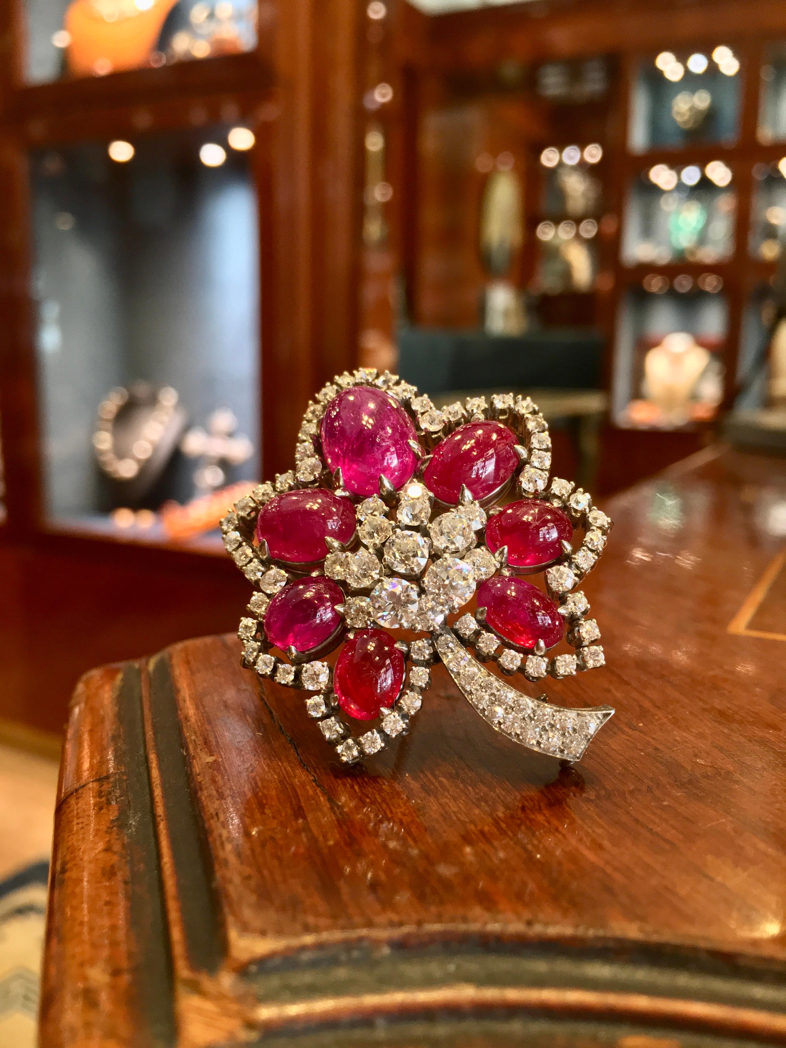 A beautiful retro flower brooch with 25 carats of cabochon rubies, and diamonds, mounted in white gold. Circa 1940s.