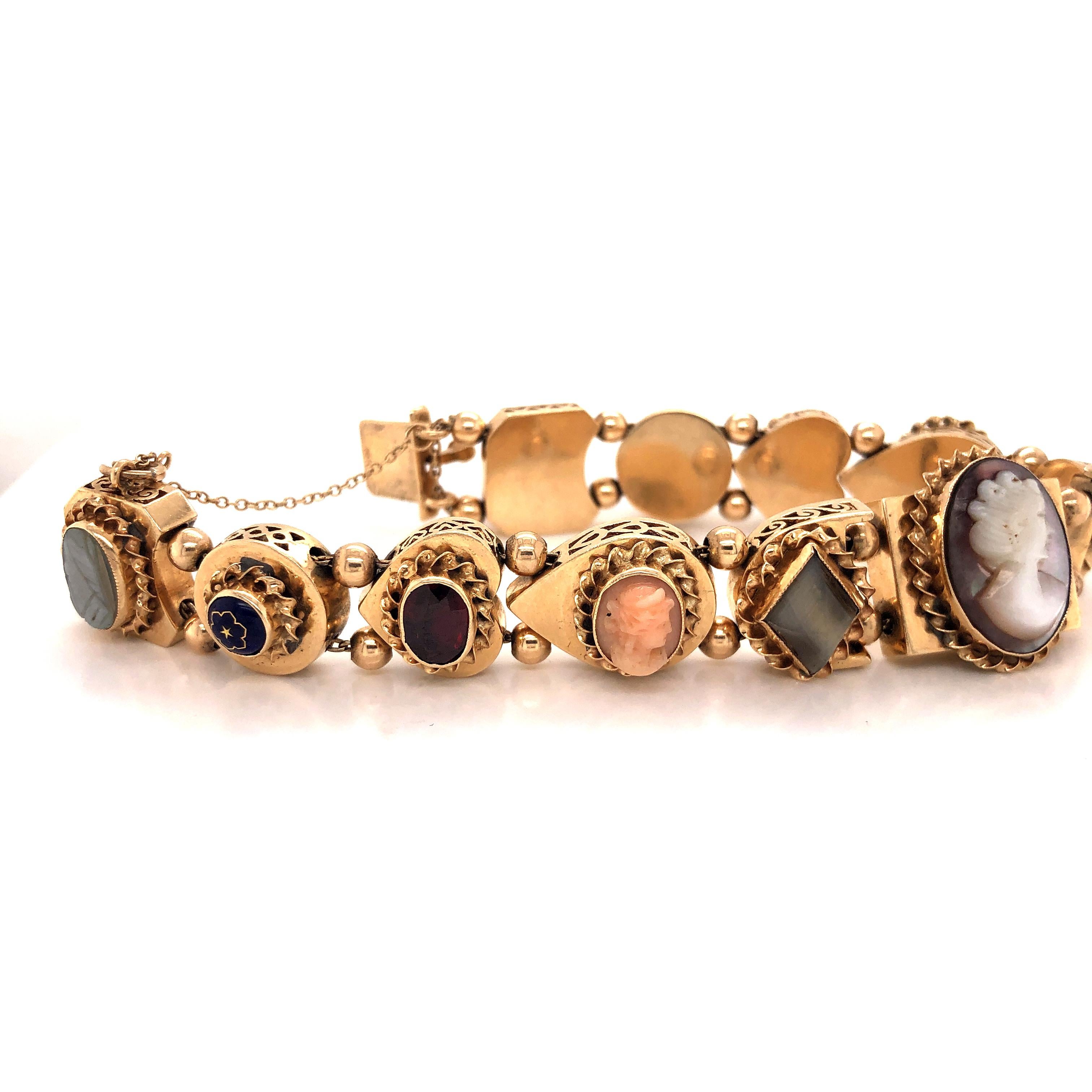 Amazing design on this vintage piece. This slider bracelet is crafted in 14k yellow gold. Amazing design is seen throughout. Multiple gemstones are faceted into this bracelet giving it a true appeal.  Mother of Pearl, Turquoise, Shell, Tigers eye,