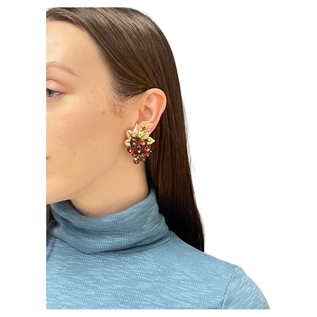 An amazing pair of Retro Cartier earrings made of 18k gold, citrine, diamond, and emerald. 
These grape earrings look very realistic, yet they showcase a highly artistic craftsmanship. 
The citrine beads are flattened and alternatively encrusted