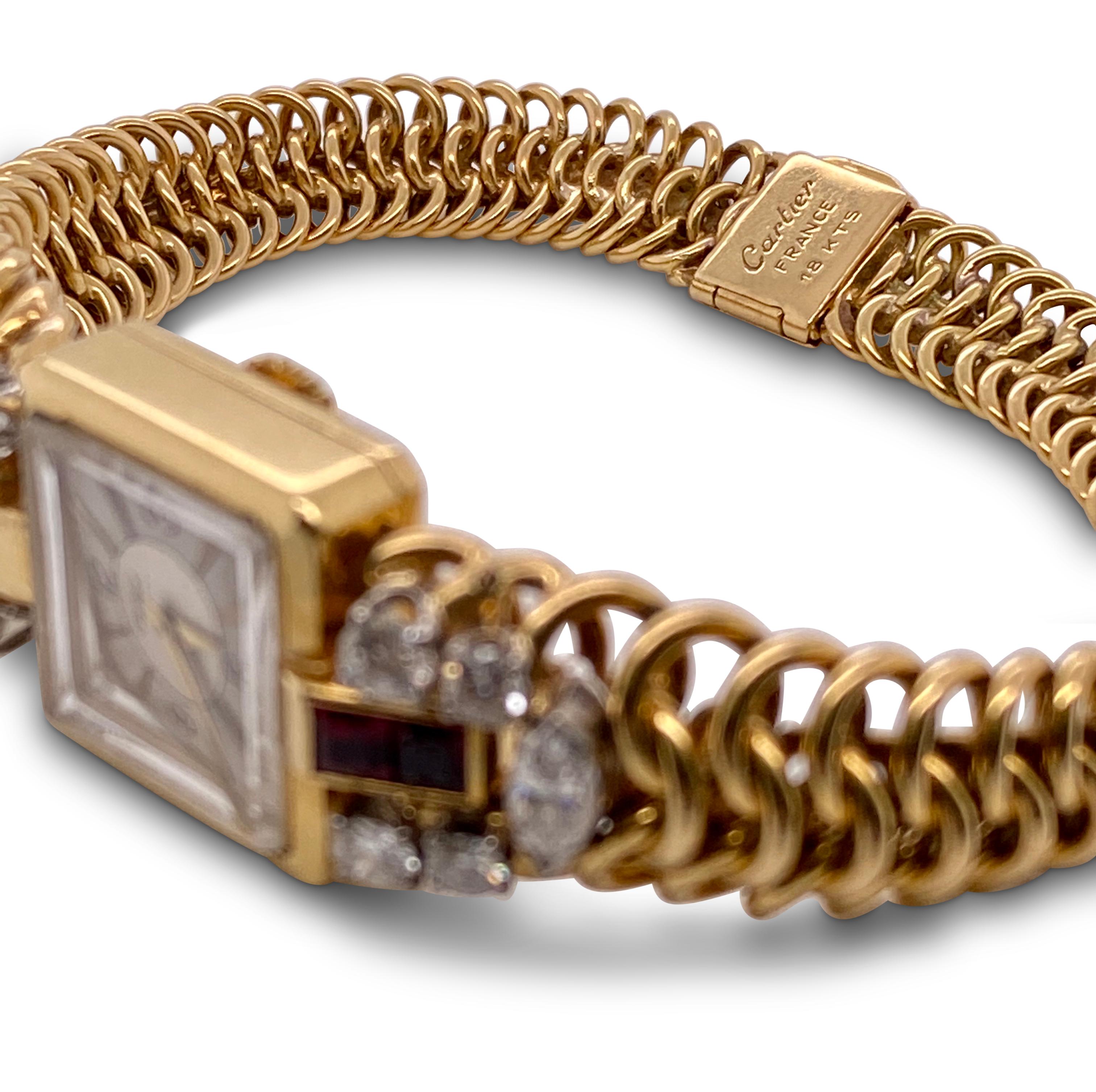 Retro Cartier ladies dress watch with an elegant woven bracelet crafted in 18 karat yellow gold. The watch is adorned with four calibre cut rubies as well as marquise and round cut diamonds weighing an estimated 1.30 carats total (H-I color, SI
