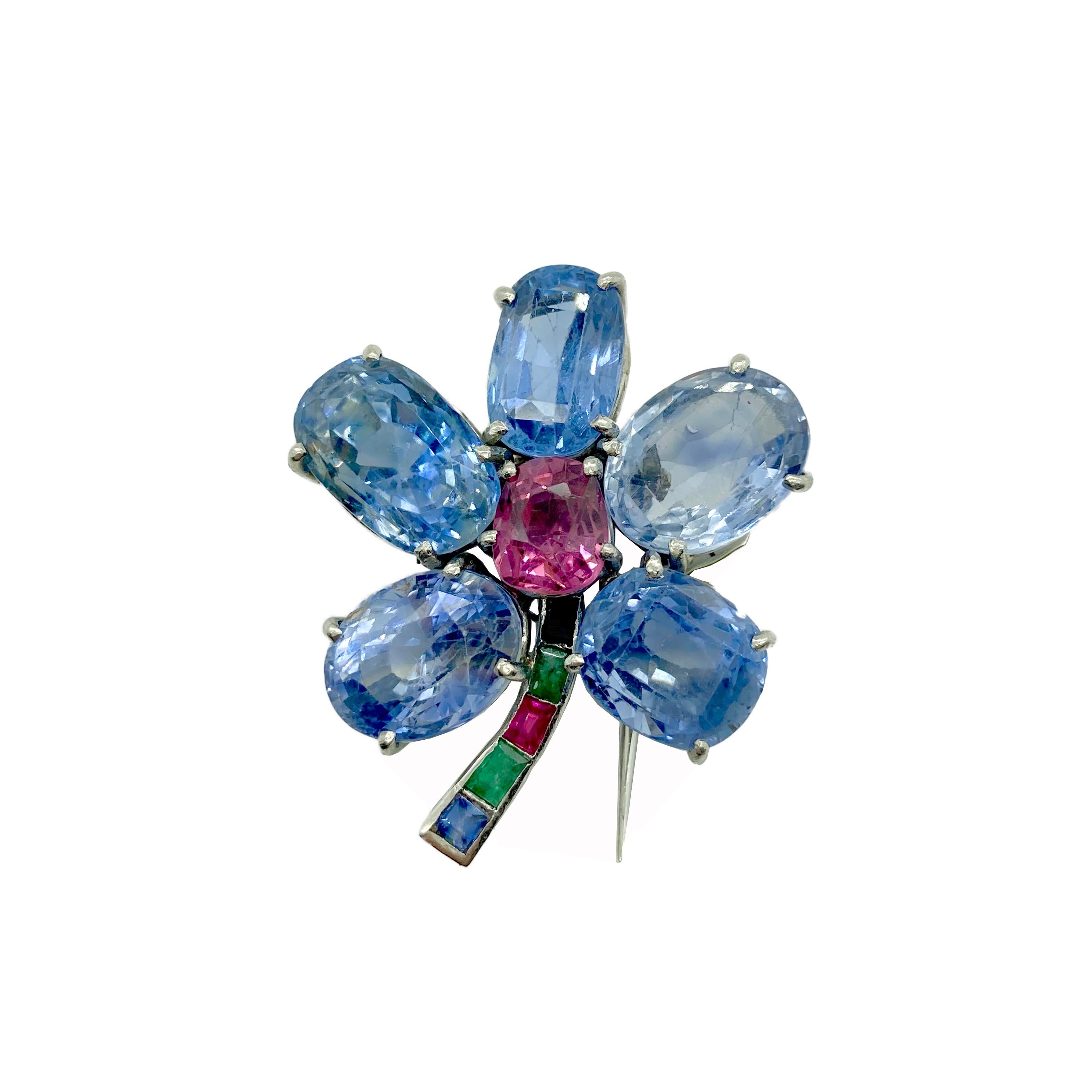 A chic retro Cartier flower brooch with sapphires, emeralds, and rubies. Circa 1940s.