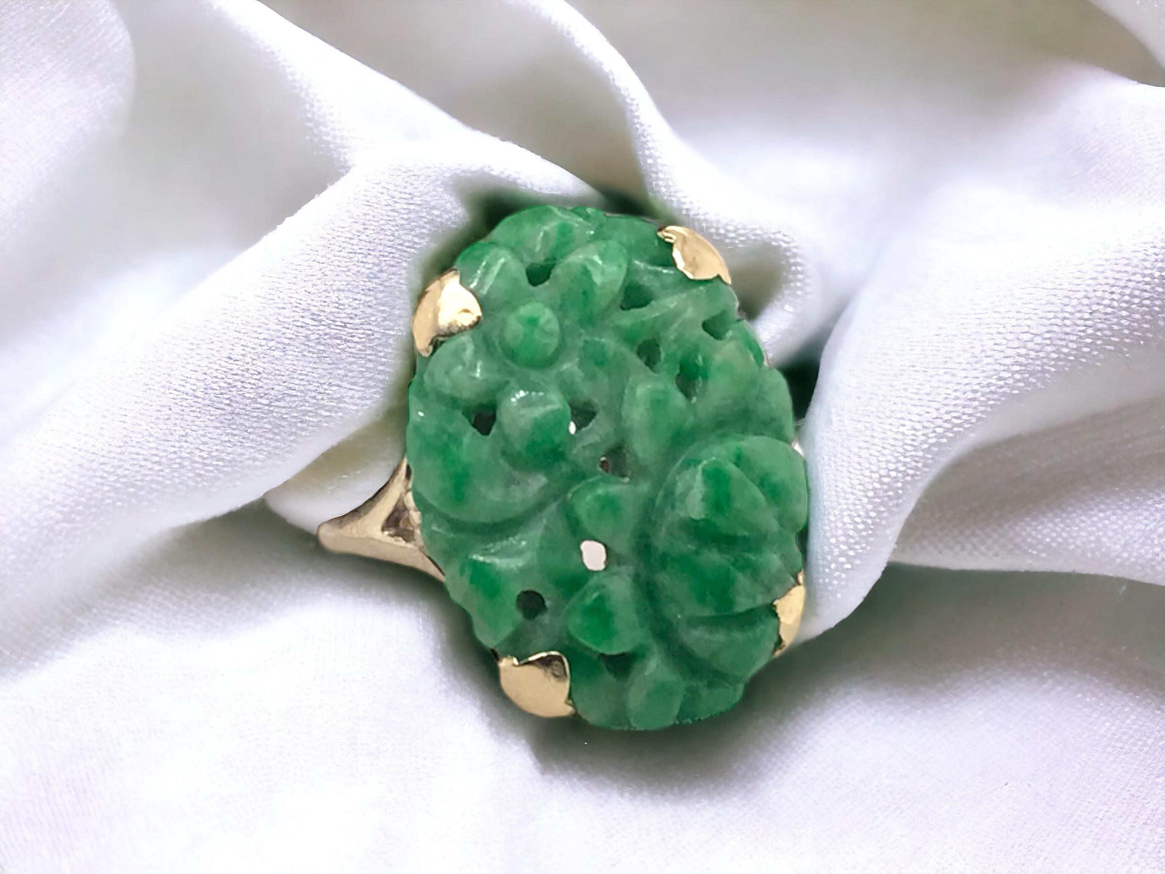 We love the hand carved details & rich green hue!

Ring Details
Era: Retro 1940 - 1960
Material: 10K Yellow Gold
Measurements: 19.9mm Length X 14.6mm Width X 4.7mm Height Off Finger
Shank Width: 2.0mm
Weight: 4.3 Grams
Finger Size: 7 1/2
Sizing