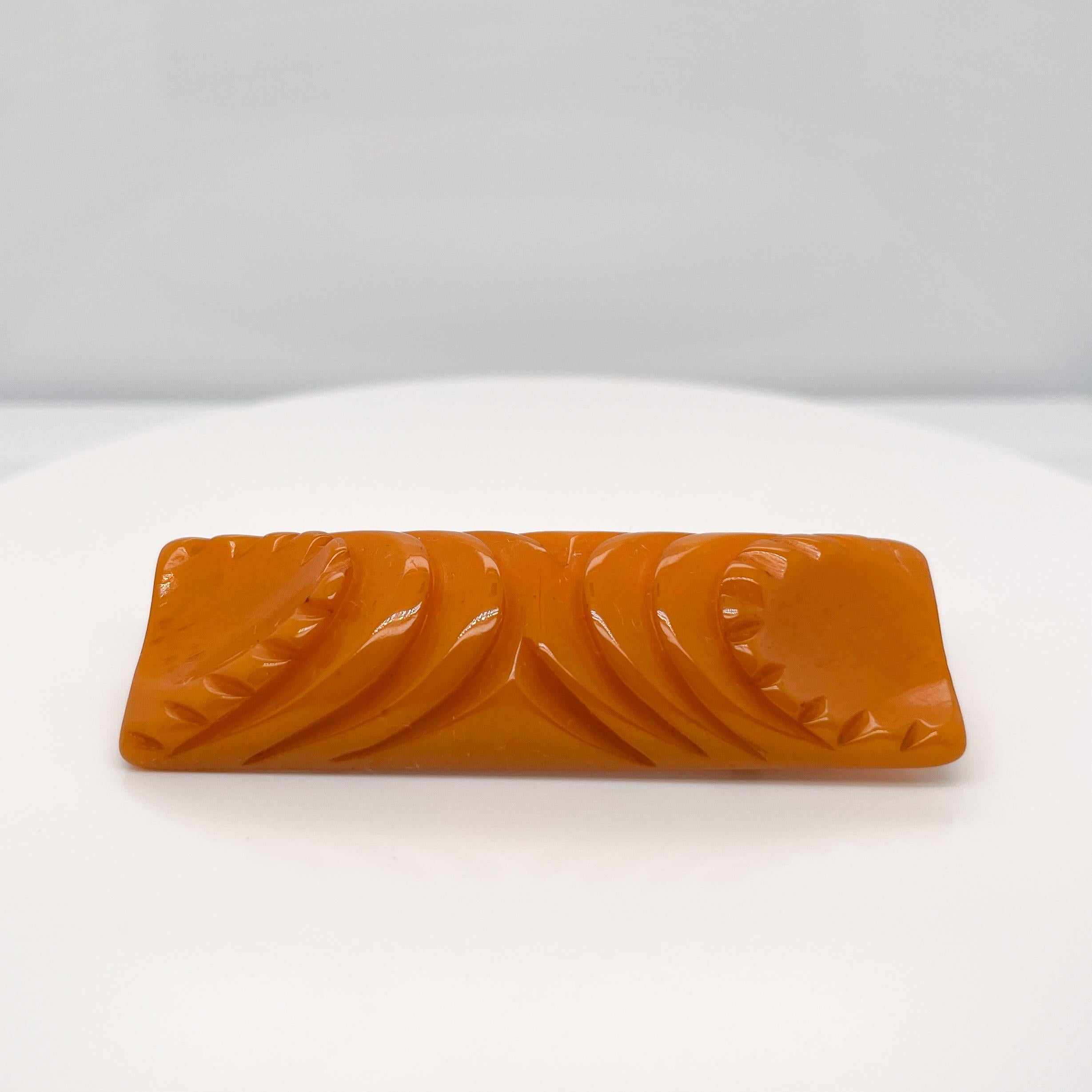 A very fine Bakelite brooch.

Art Deco style with deeply carved decoration.

Simply a great brooch!

Date:
Mid-20th Century

Overall Condition:
It is in overall good, as-pictured, used estate condition with some very fine & light surface scratches