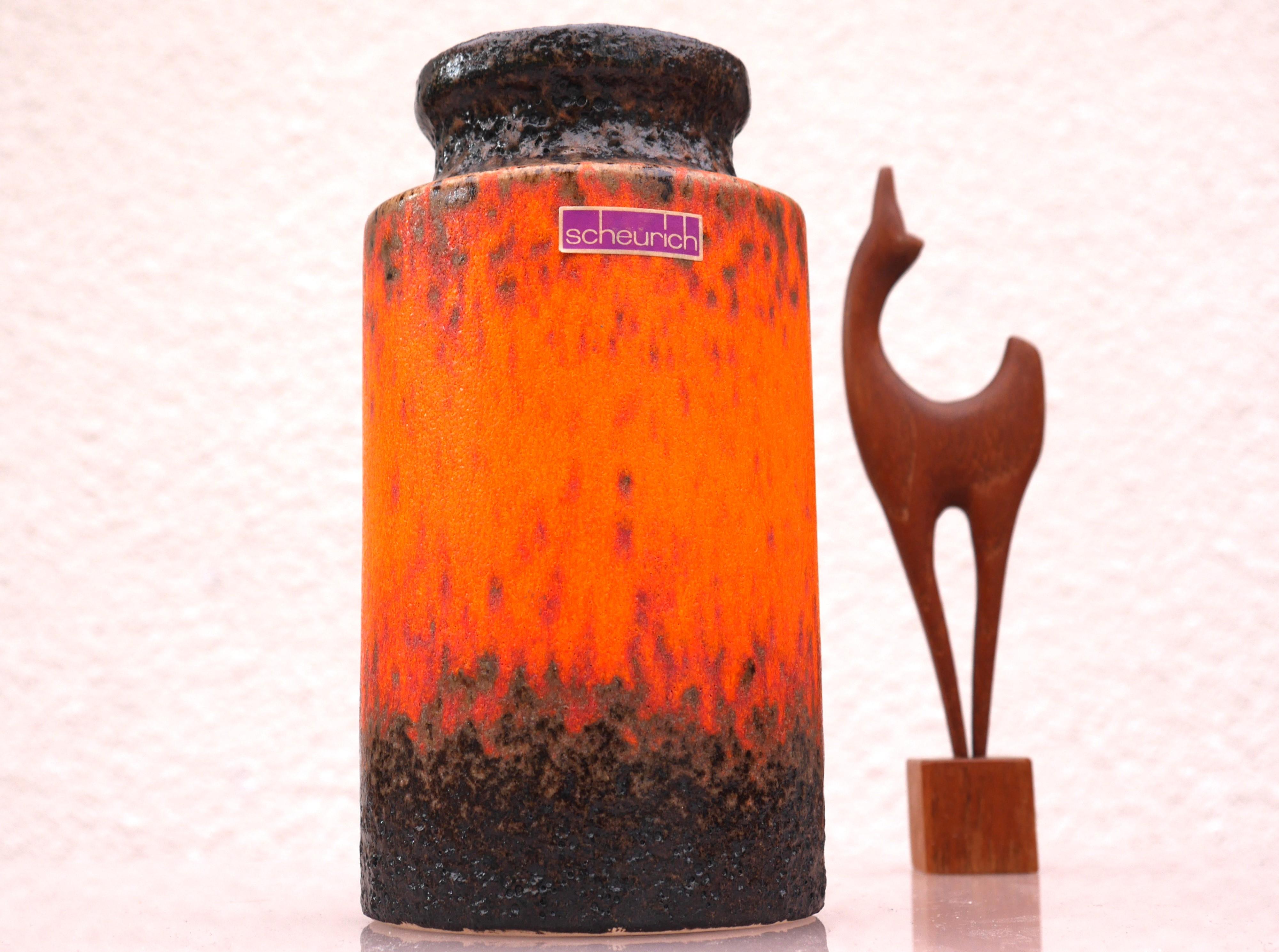 A very special fat lava ceramic vase from Scheurich. The color on this vase is a fiery orange with a dark base and top and various nuances of yellow and red details. This vase is very much of its time, yet still has a modern feeling to it and it is