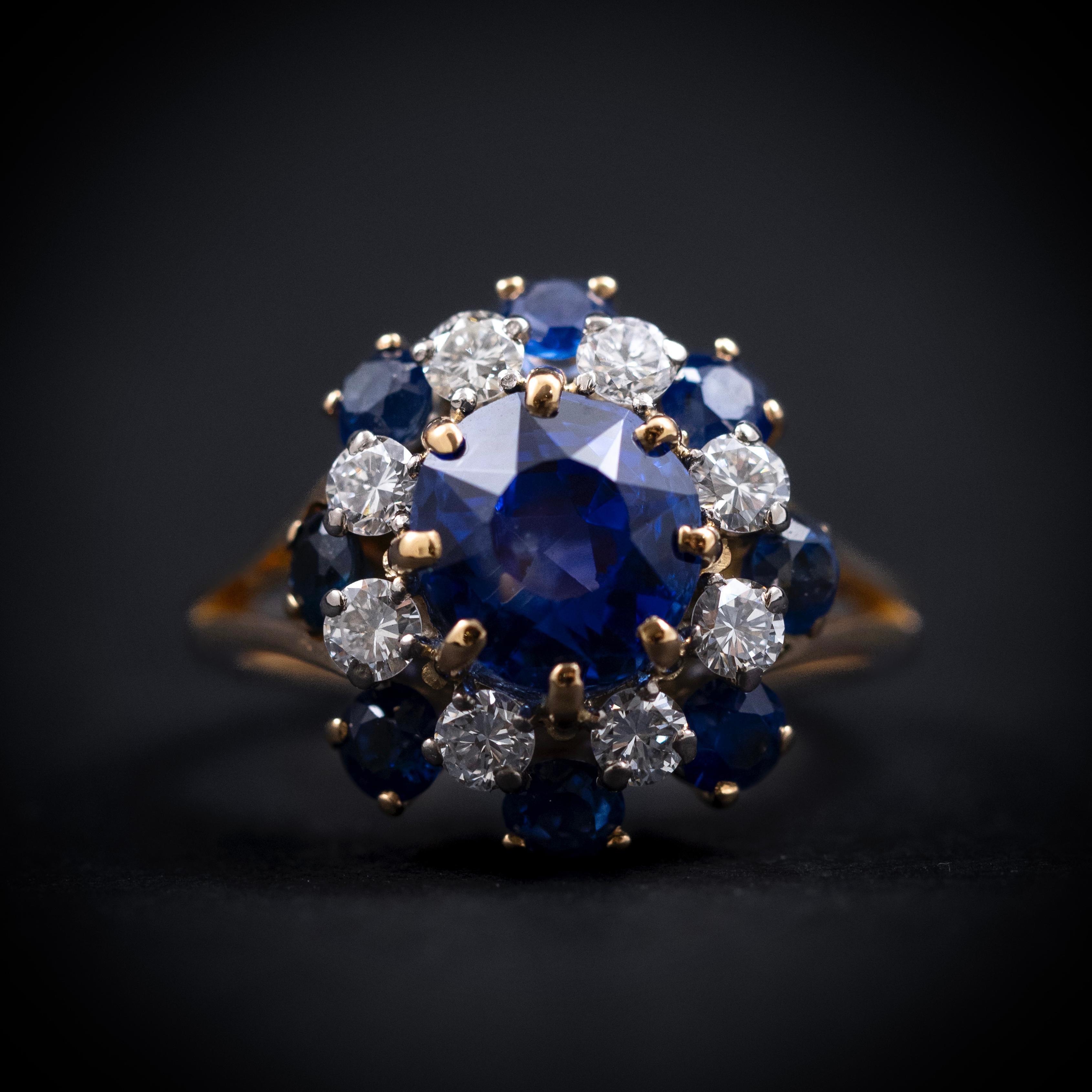 A striking vintage sapphire and diamond cocktail ring from the 1940s, crafted in polished yellow gold. The centerpiece is a certified natural no-heat cushion-cut sapphire of 4.00 carats, displaying a deep blue hue, secured by eight delicate claws.