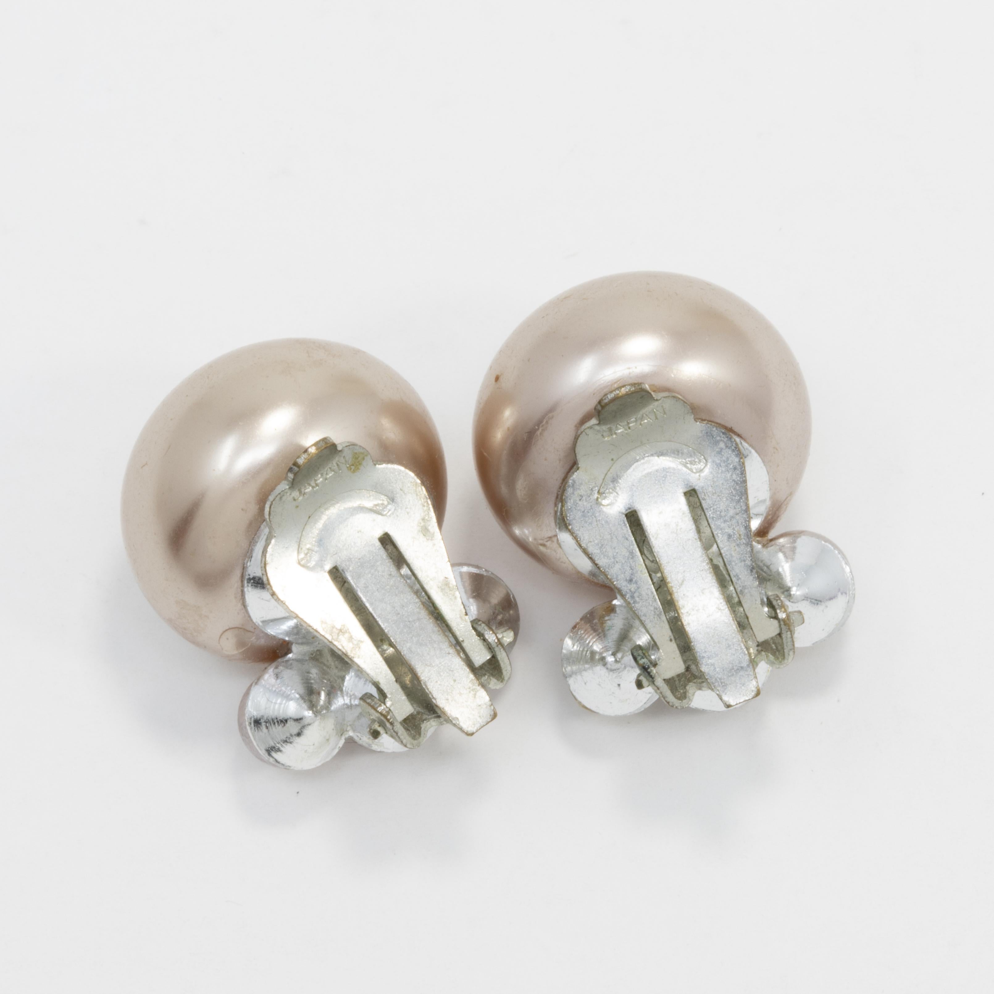 A pair of stylish retro clip on earrings, each featuring a cluster of lilac-tone faux pearls set on silvertone clips.
