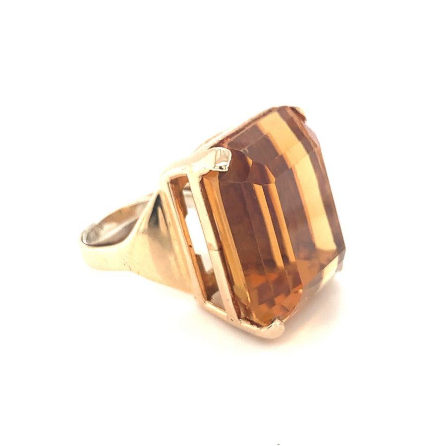 One Retro citrine 14K rose gold ring featuring one prong set, cushion-emerald cut citrine weighing 50 ct. with deep amber tones. Circa 1940s.

Gleaming, vibrant, superb.

Additional information:
Metal: 14K rose gold
Gemstone: Citrine = 50 ct.
Circa: