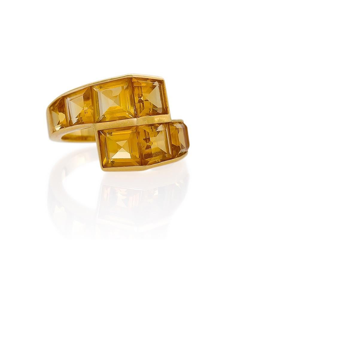 A Retro 18 karat gold ring with citrines. The ring has 8 square-cut citrines with an approximate total weight of 3.80 carats. The ring is designed in a dimensional crossover motif. Circa 1940's.

Ring size 6-1/2; this ring can be sized.