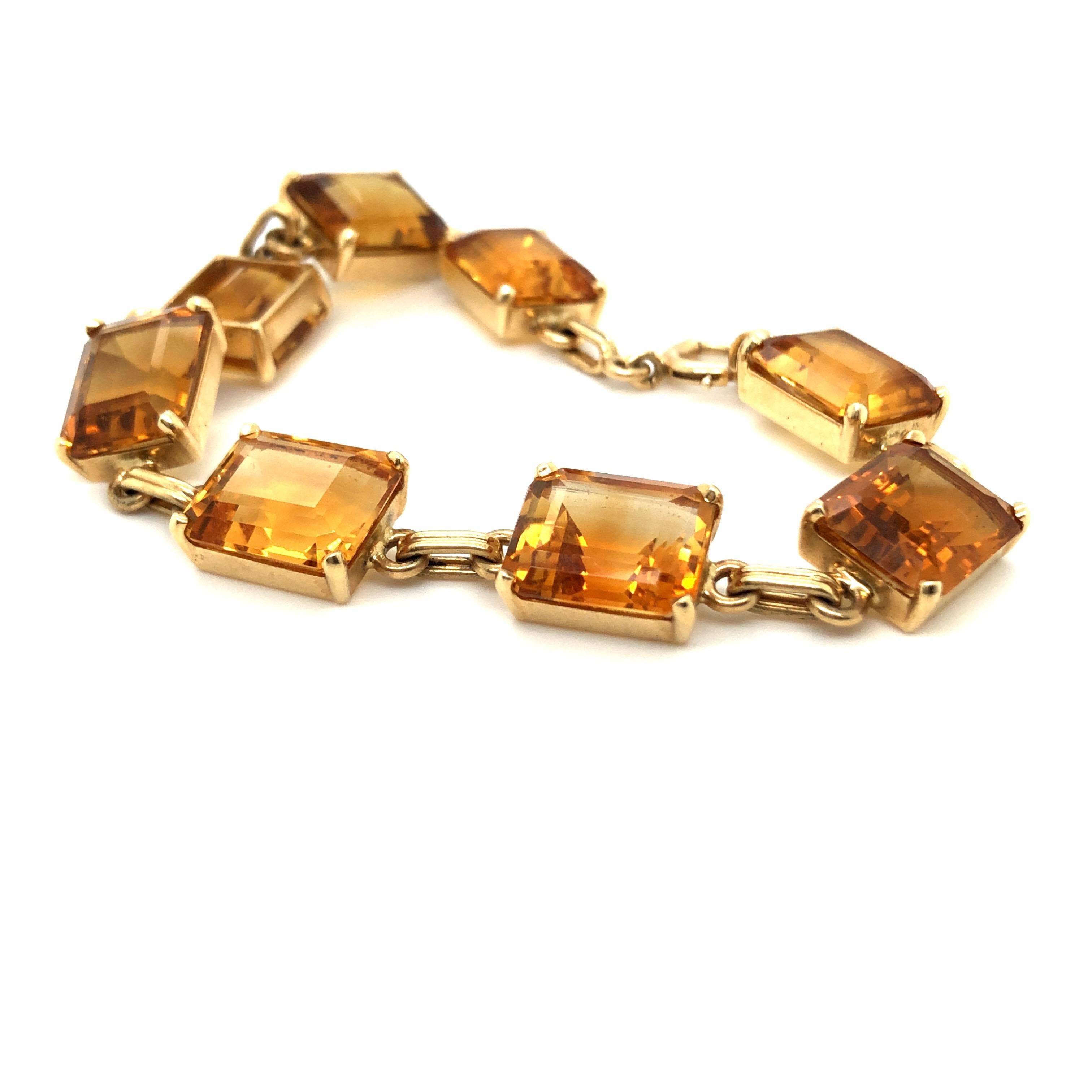 14 karat yellow gold retro citrine bracelet by Tiffany & Co, circa 1950.
Stylish citrine bracelet by Tiffany & Co., composed of 8 rectangular-cut citrines (totalling about 45 carats) interspersed by a cable-link chain in 14 karat yellow gold. This