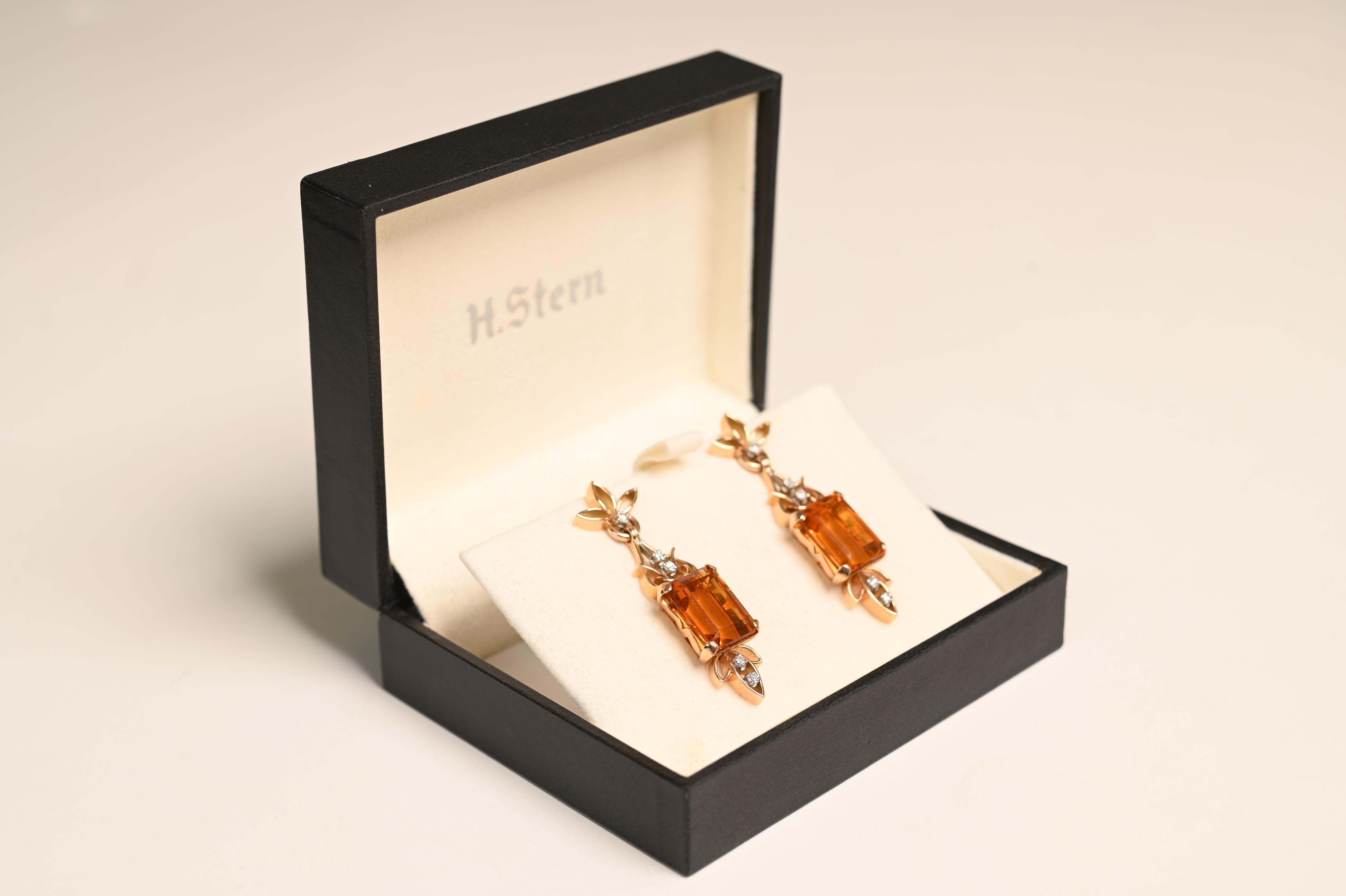 These striking vintage earrings hail from the bold and glamorous Retro era, circa 1940. Each earring features a richly hued emerald-cut citrine—one weighing Approx. 9.1-Carats and the other Approx. 8.4-Carats—set in elegant 18k yellow gold. The