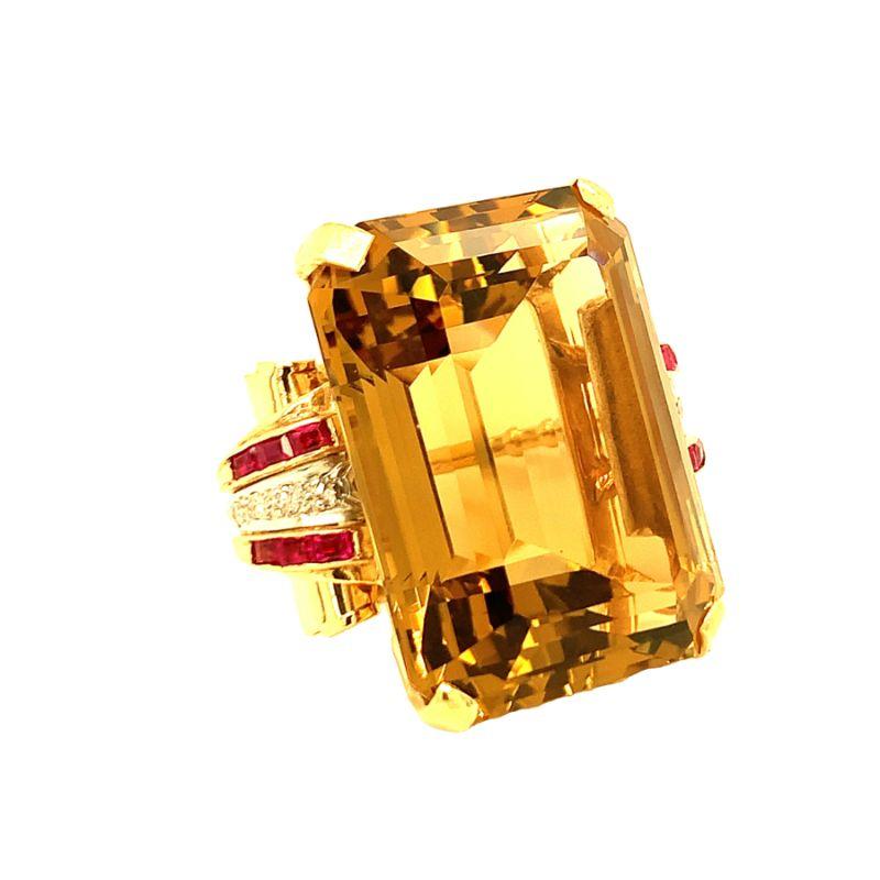 One Retro citrine, ruby and diamond 14K rose and yellow gold cocktail ring centering one prong set, emerald cut citrine weighing approximately 78 ct. flanked by ruby and diamond accents on each side.

Additional information:
Metal: 14K rose and
