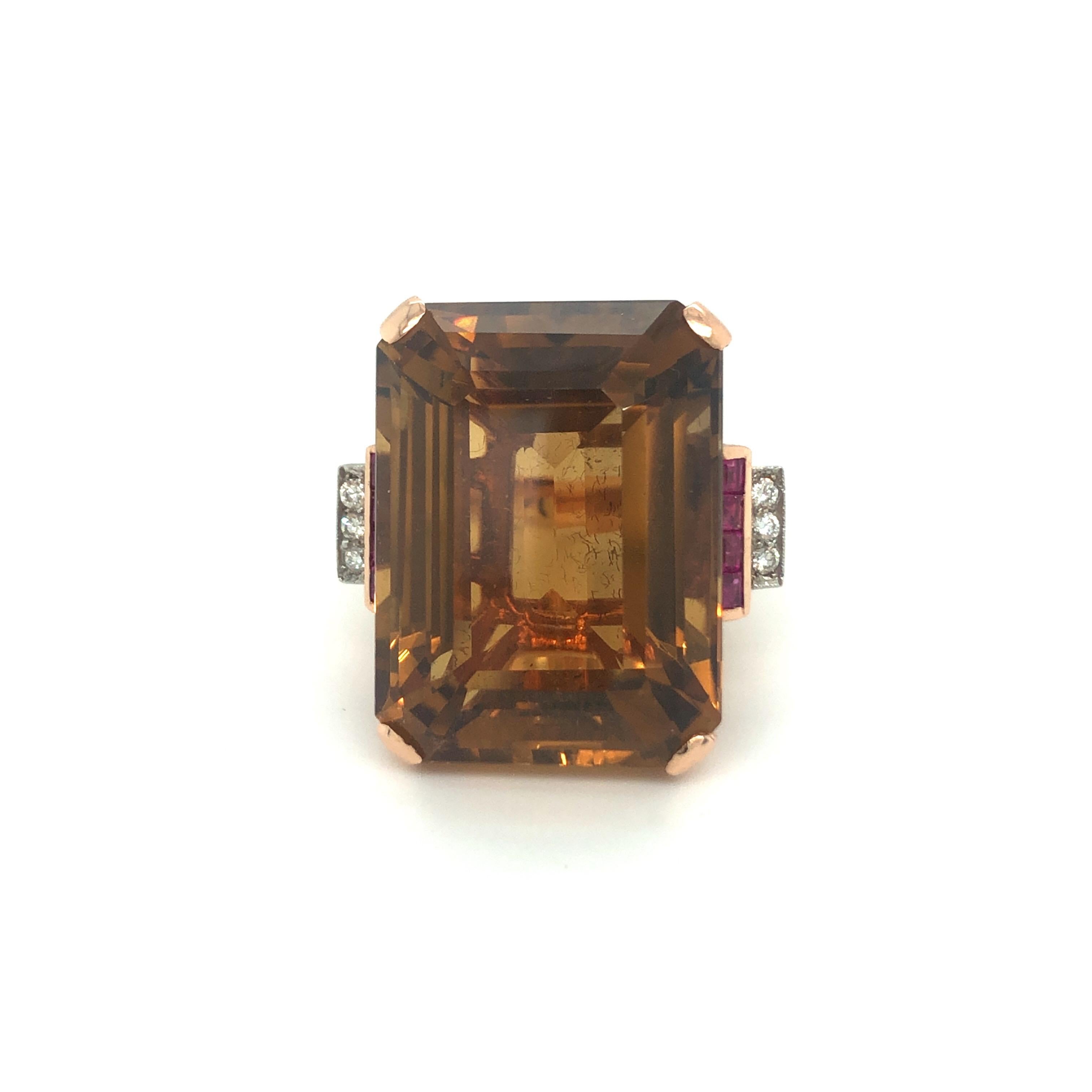 Eye-catching citrine, ruby and diamond 14 karat rose gold cocktail ring, circa 1945.
Crafted in 14 karat rose gold and claw-set with an impressive honey-coloured citrine between tapering shoulders of square-cut rubies and brilliant-cut diamonds.