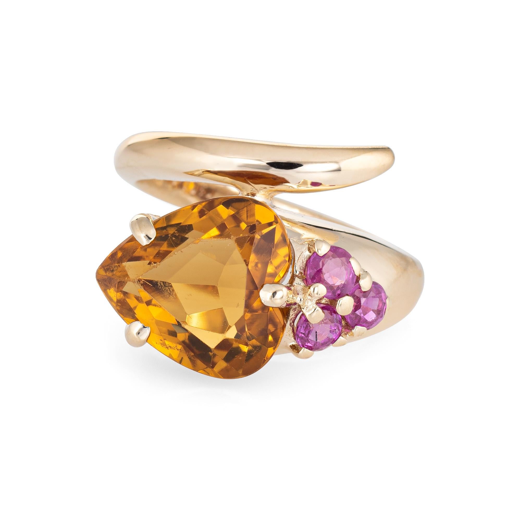 Retro vintage citrine & ruby snake ring (circa 1940s to 1950s) crafted in 14 karat yellow gold. 

Faceted heart cut citrine is estimated at 5 carats, accented with an estimated 0.15 carats of rubies.  

The citrine and rubies are set in a stylized