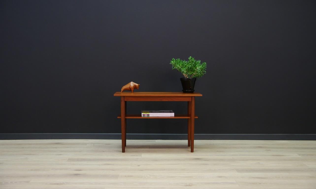 Classic coffee table from the 1960s-1970s, Danish design. The form is veneered with teak. Preserved in good condition (visible small dings and scratches), directly for use.

Dimensions: Height 50 cm, table top 74.5 cm x 40 cm, shelf height 30 cm,