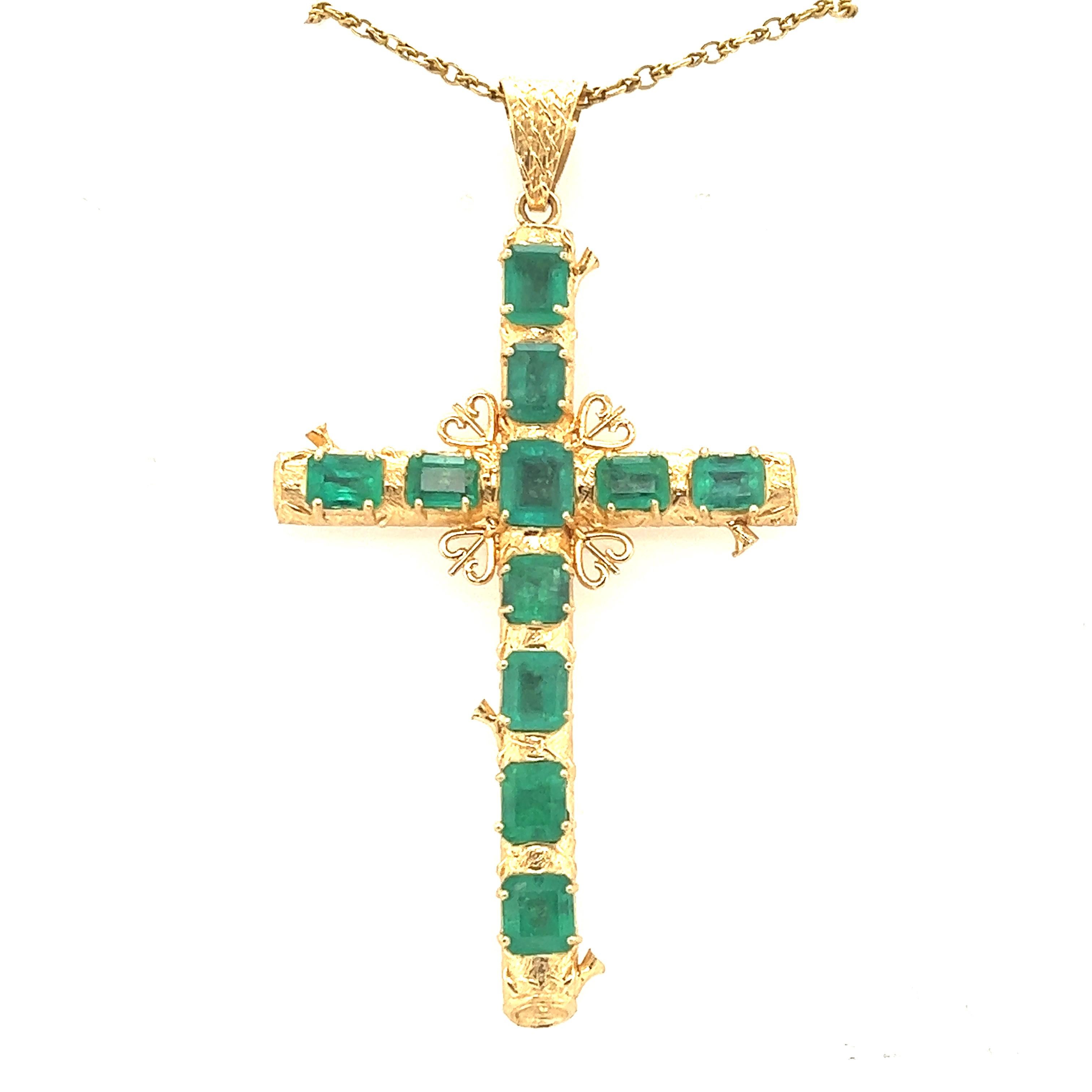 gold cross with emeralds