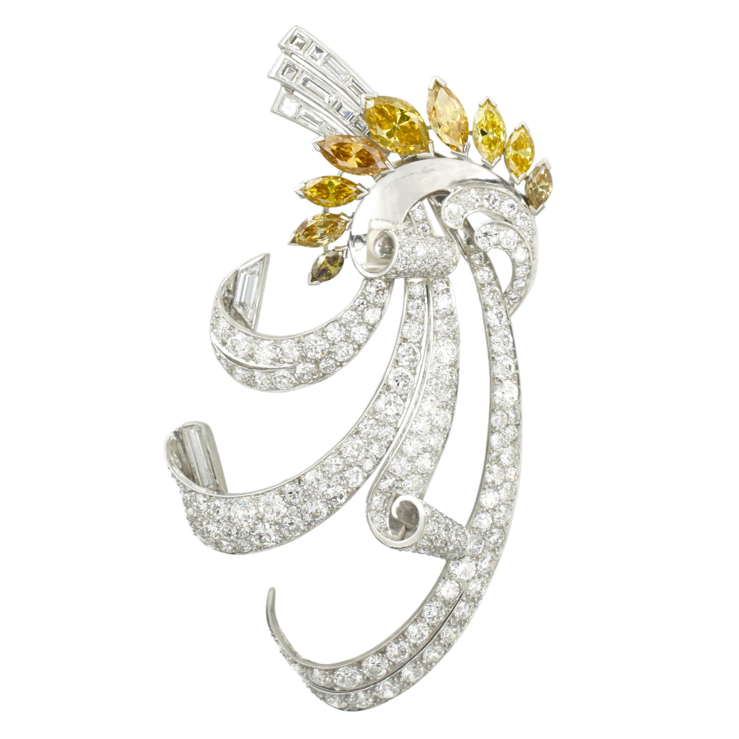 Circa 1940's.  Antique yellow and white diamond Diamond Clip-Brooch. This brooch features scrolled design
encrusted with total of approximately 9.55 carats of old Euro cut diamonds and old rectangular cut diamonds with total weight of approximately