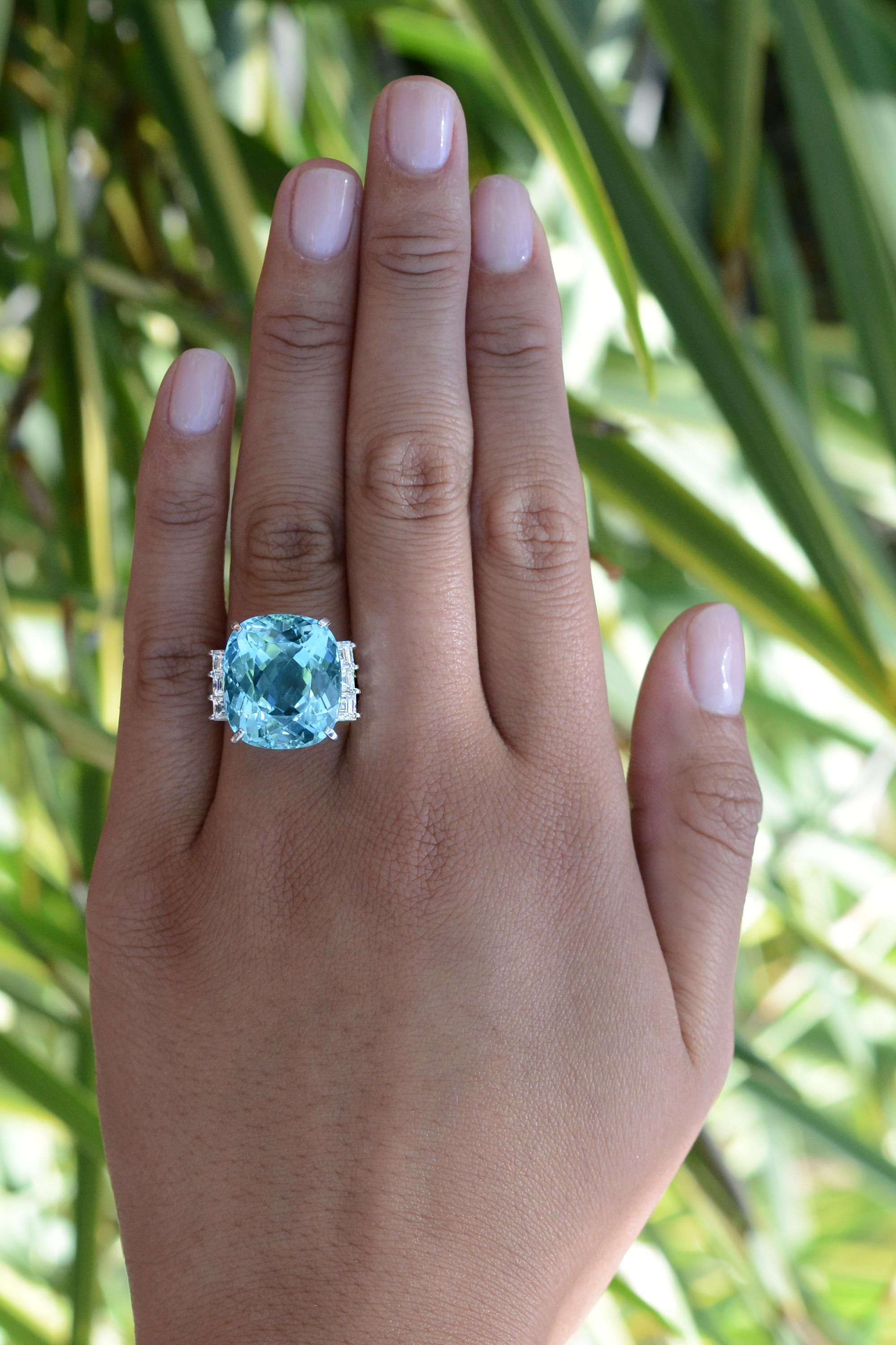 This cocktail ring features the most amazing aquamarine you've ever seen. The large, 20.75 carat gemstone portrays exemplary color found exclusively in Brazil's Santa Maria mines. The expert faceting and fascinating cut allows for even color