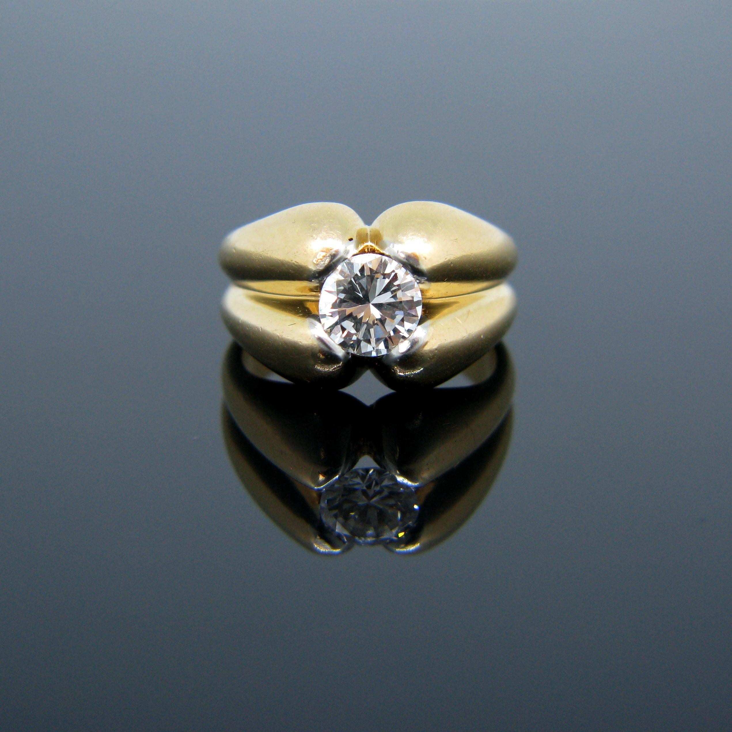 This beautiful ring is very Retro with its bold yellow gold design. It is set with a round cut diamond weighing around 1.10ct with good clarity VS1 and great colour E/F. It truly is a beautiful stone set in a bold design made in 18kt yellow gold and