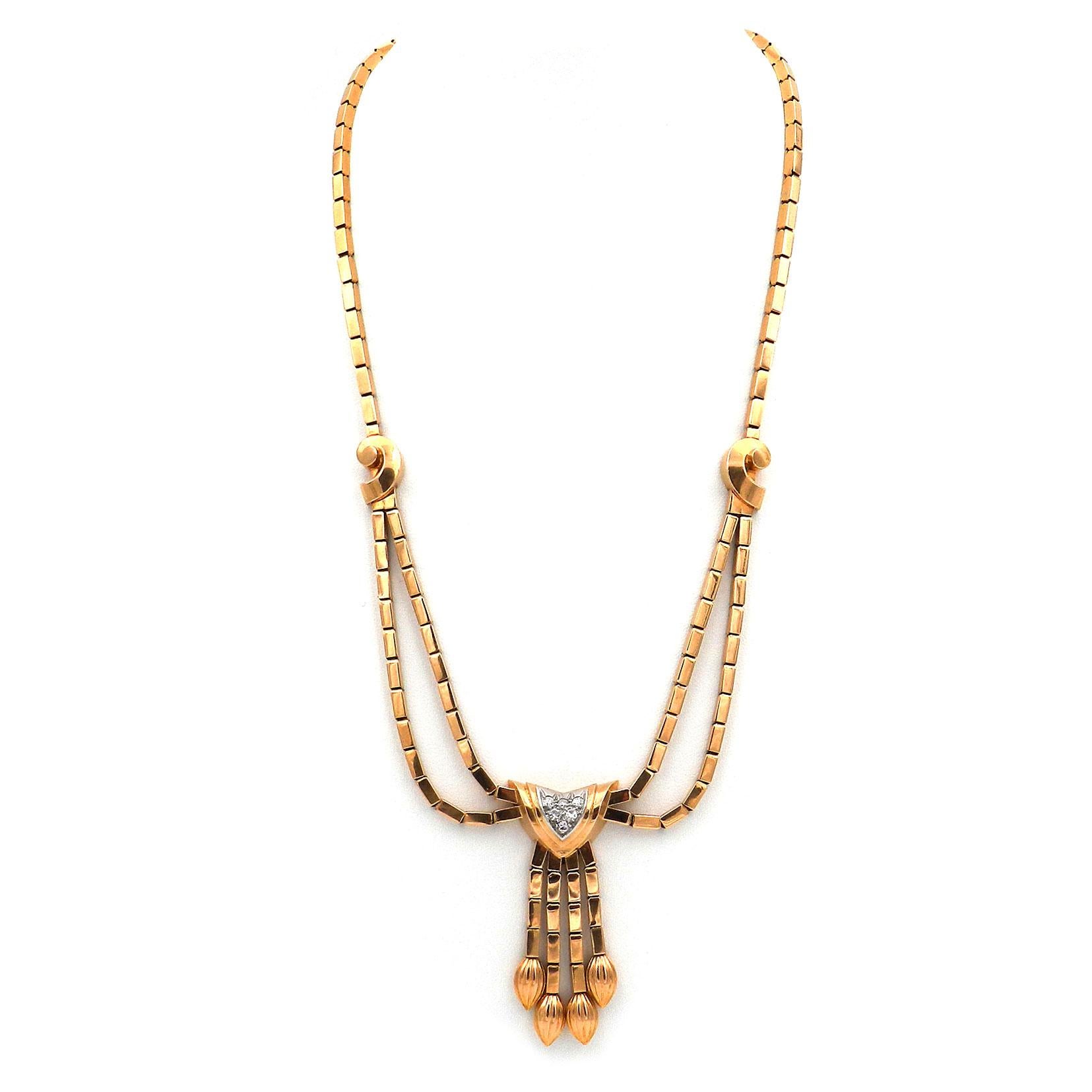 Retro Diamond 18K Gold and Platinum Necklace, Paris circa 1945

Elegant, wonderfully flowing Retro necklace made of rod-shaped links, the face side with snail-shaped applications, designed in two rows and ending in a diamond-set fringe pendant.
