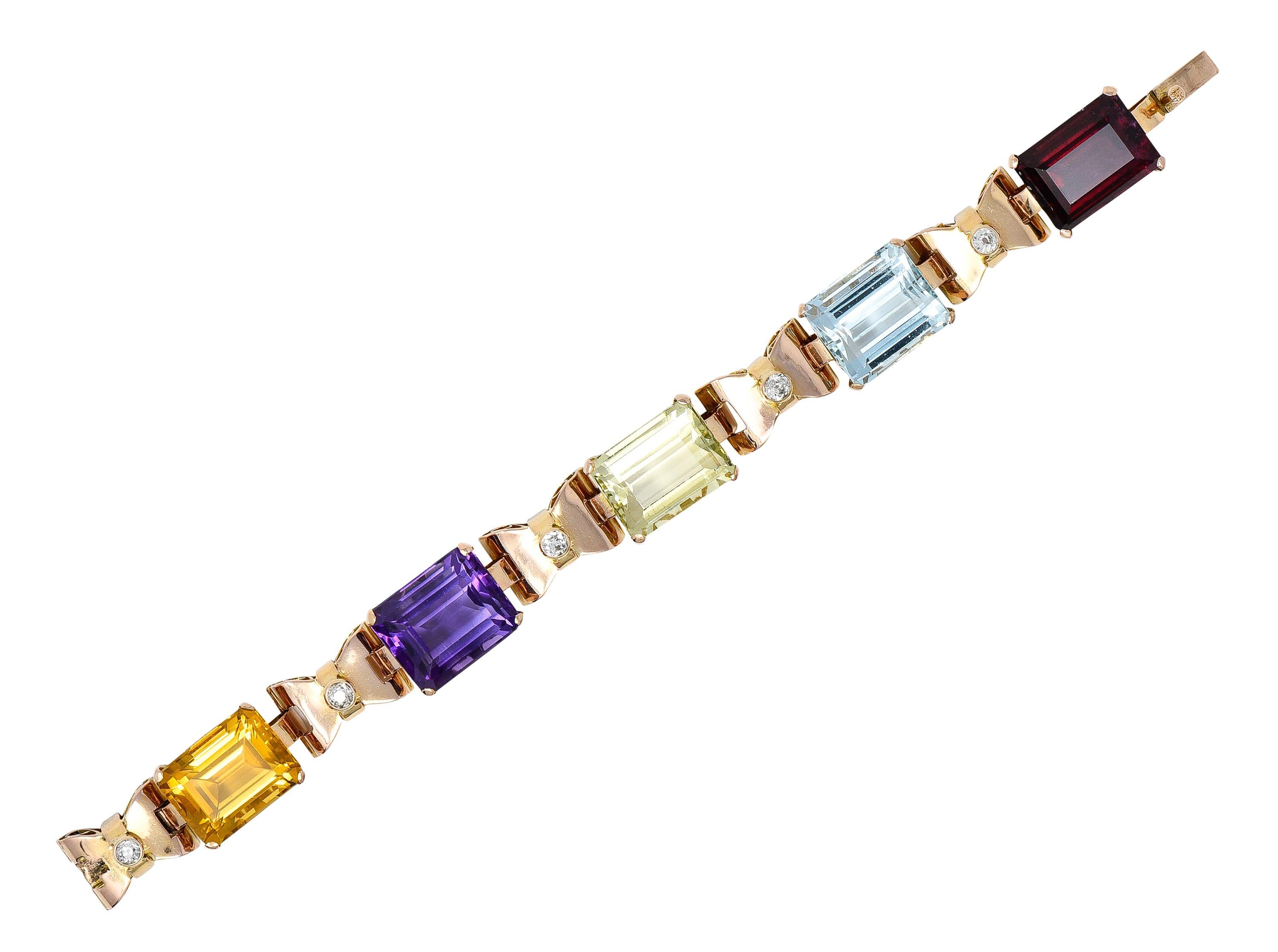 Comprised of alternating hinged basket and bow links with pierced scroll motif profile. Basket links feature emerald cut amethyst, aquamarine, citrine, and tourmaline. Transparent light/medium purple, blue, orangey brown, green, and pinkish red in