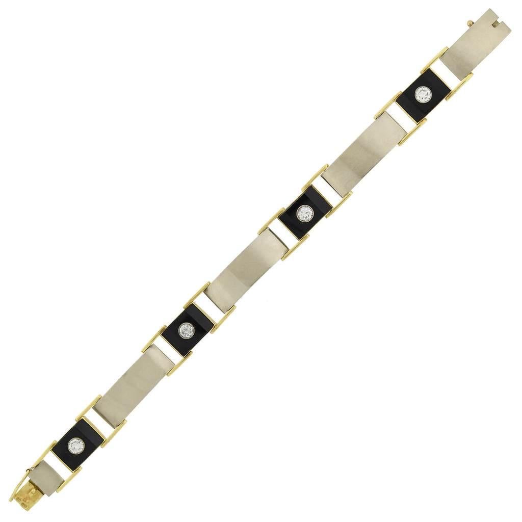 A stunning Retro diamond and onyx link bracelet from the 1940s era! This incredible Edwardian-inspired piece is crafted in 14kt yellow and white gold and comprised of four carved onyx links and four curved yellow gold links topped with white gold.