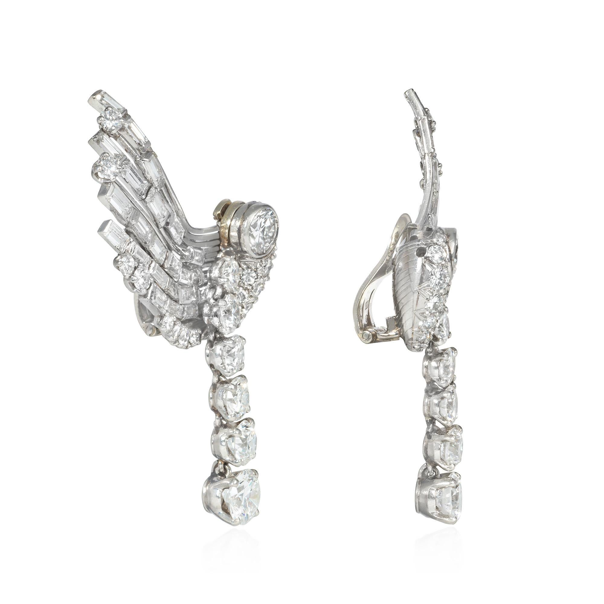 A pair of Retro diamond clip earrings designed as stylized wings, each with a removable pendant of tapering diamonds, in platinum and 18k white gold. French import.  Atw 7.50 cts.  Pendants in different gemstones may be fabricated to allow for a