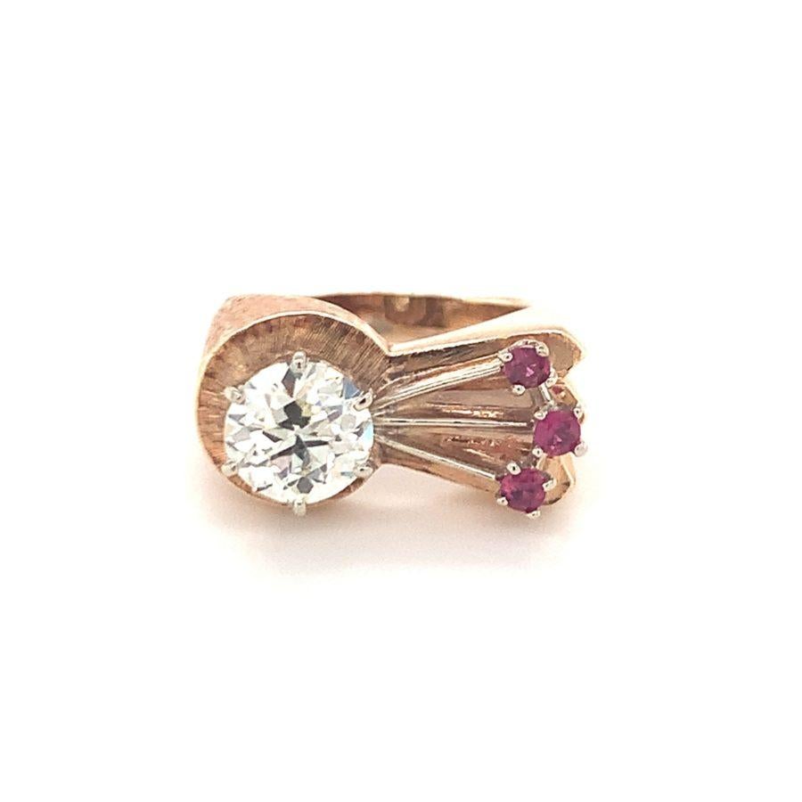 Diamond and ruby ring in 14K rose gold from the Retro period centering one old European cut diamond weighing 1.70 ct. with M color and VS-2 clarity. Enhanced by 3 round cut rubies totaling 0.25 ct.

Delightful, pleasing, charming.

Additional