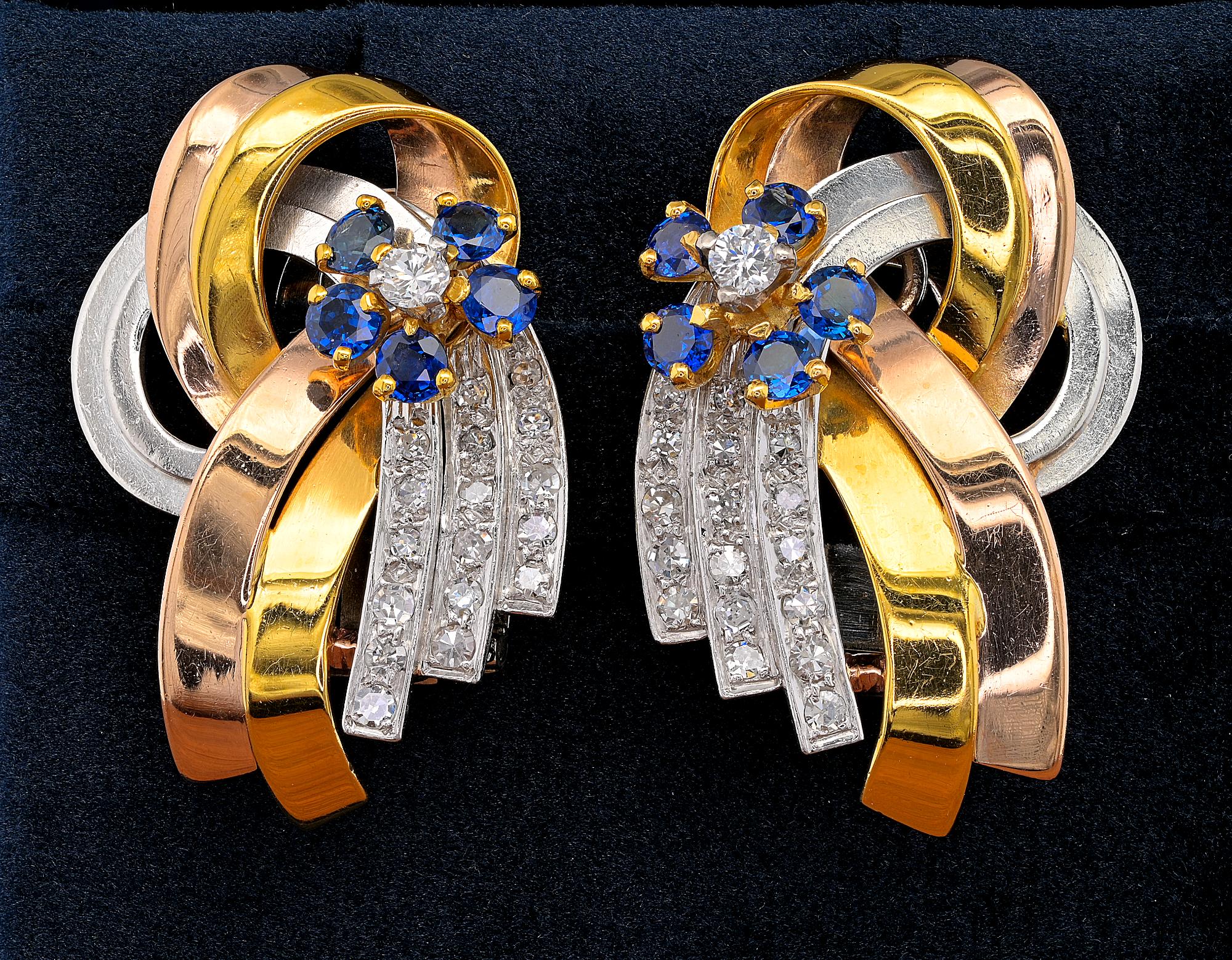 Appealing bow design epitome of the elegance of retro era, skilfully hand made of solid 18 Kt bi- colour gold from the 40’s - The large, articulated knotted bow is embellished by a centre daisy flower set with Sapphires & Diamonds laid on three rows
