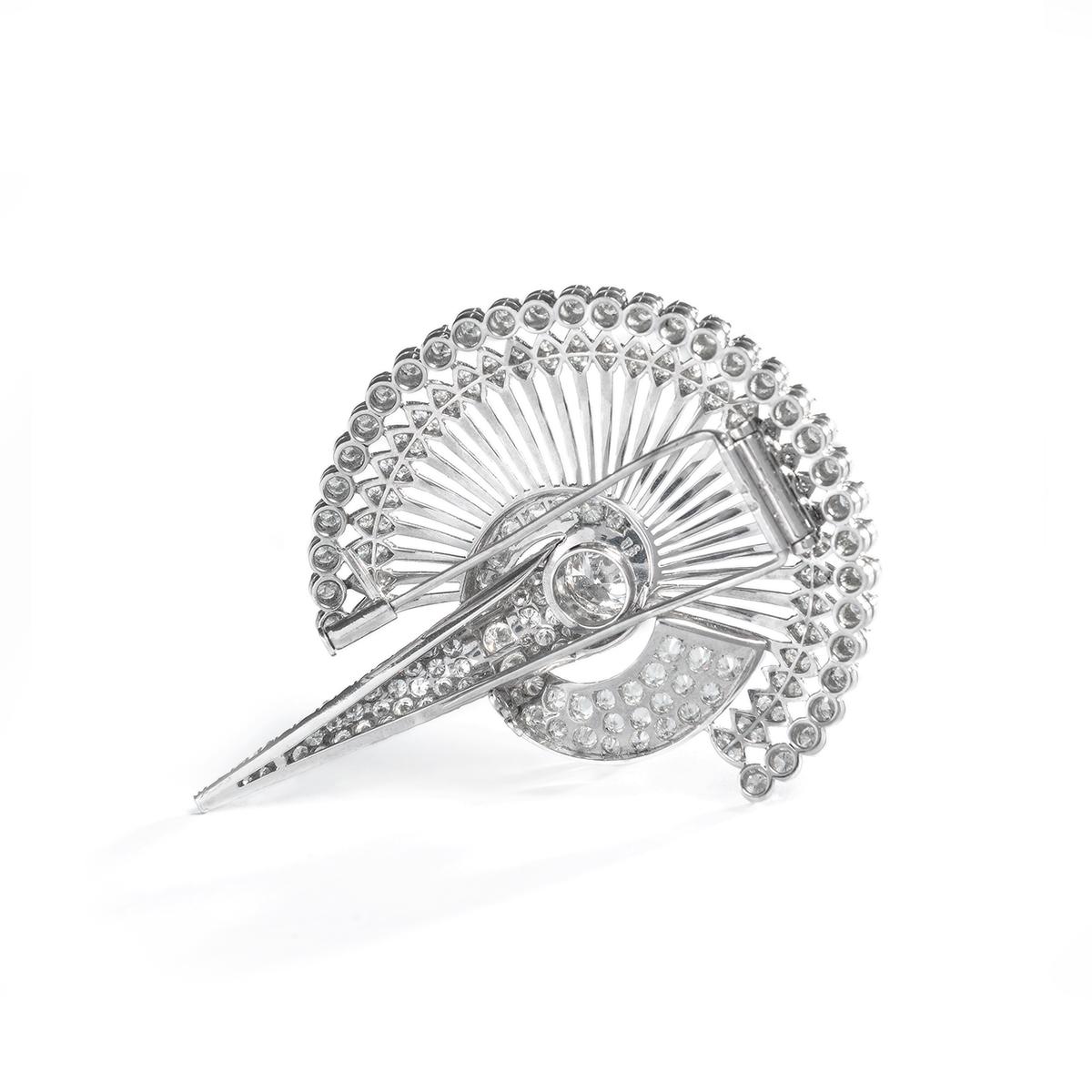 Retro Diamond and Platinum Clip Brooch.
Set with a central brilliant-cut diamond, weighing approximately 2.0-2.5 carats, G-H color, VVS-VS clarity. Pavé-set with brilliant-cut and single-cut diamonds, weighing a total of approximately 5-7 carats,