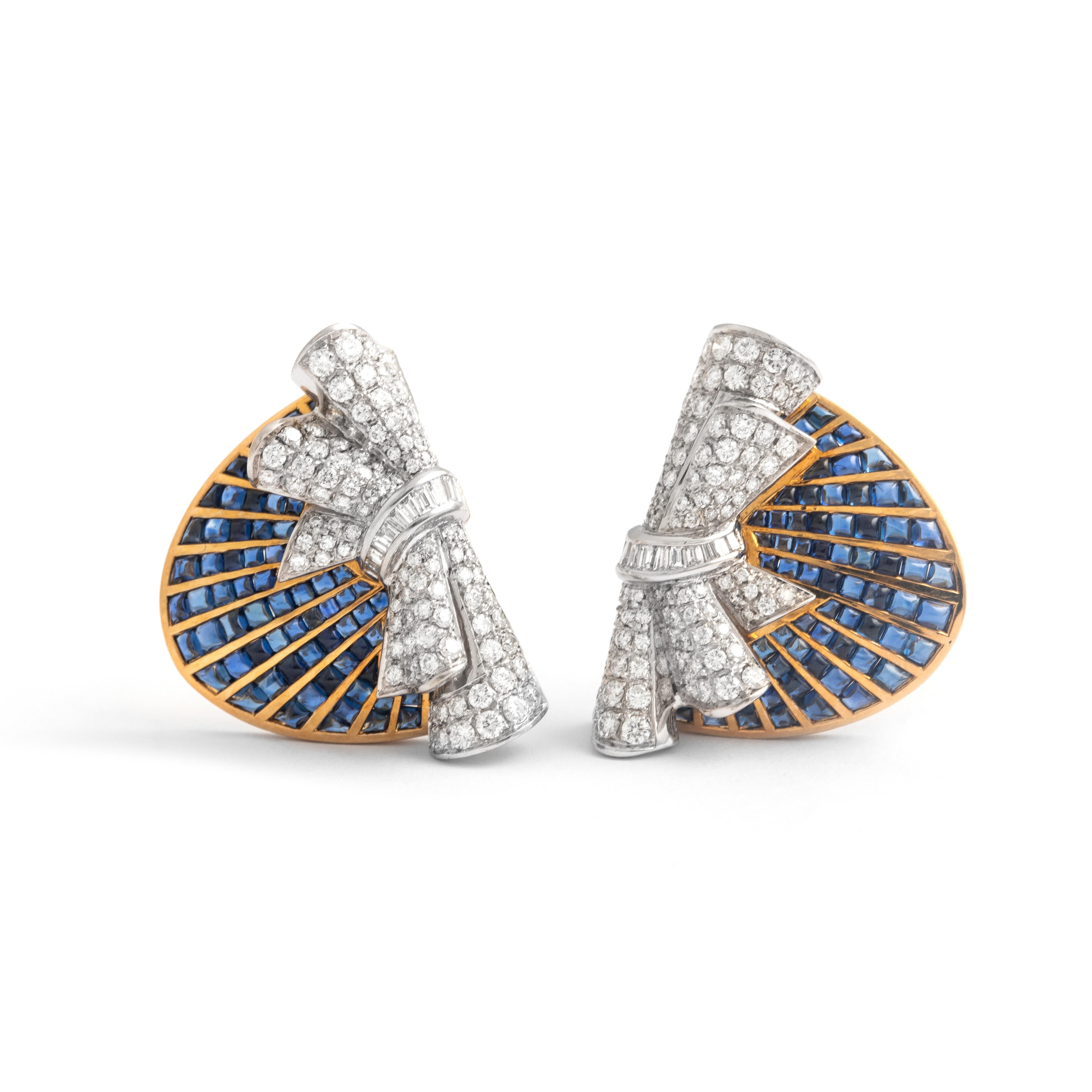 Retro Diamond Calibrated Sapphire Yellow and White Gold EarClips Earrings.
Circa 1970.

Dimensions: 
Height: 3.00 centimeters
Width: 2.50 centimeters
Thickness: 0.20 centimeters up to 1.00 centimeters

Total weight: 31.82 grams