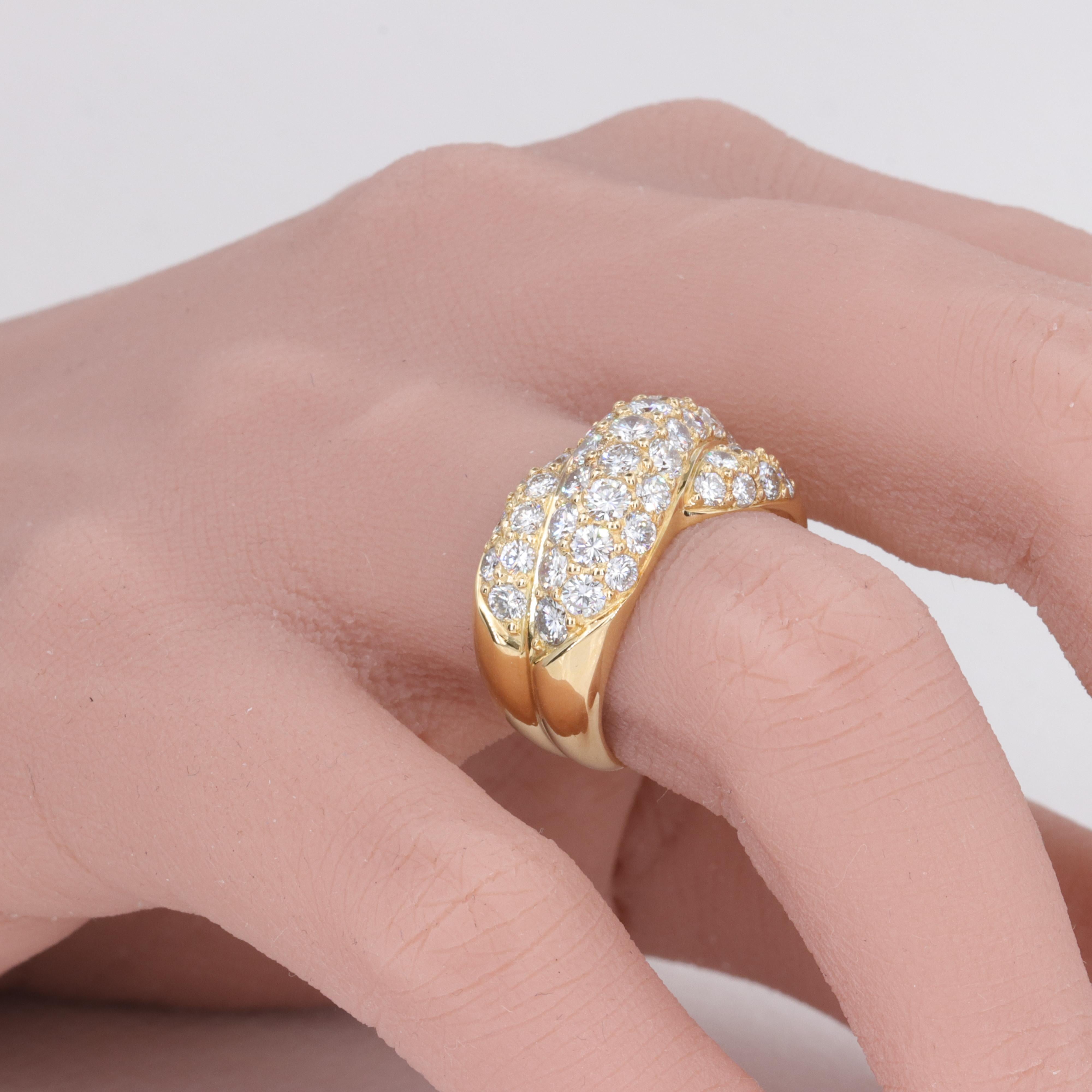 3.35 Carat Diamond and 18 Karat Yellow Gold Cross Over Domed Band 

A finely made diamond and 18 karat yellow gold band, hand set with approximately 3.55 carats of D-F color, VVS-VS clarity diamonds in hand cut a jour. 

The band is a size 5.75 US